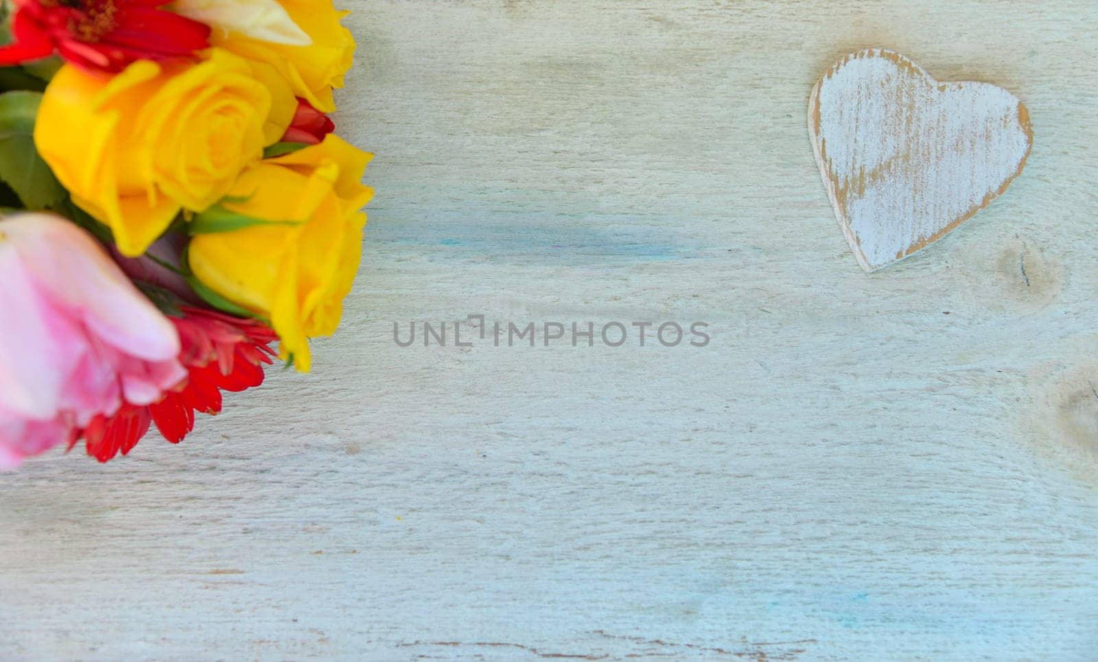 Roses and heart on wood background