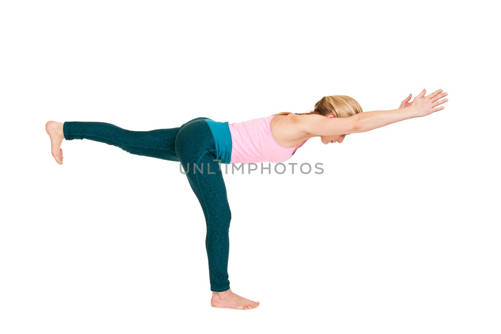 Lateral full-body view of a young woman during yoga exercise "the Warrior 3"" (Virabhadrasana III) against a white background with a slight shadow"