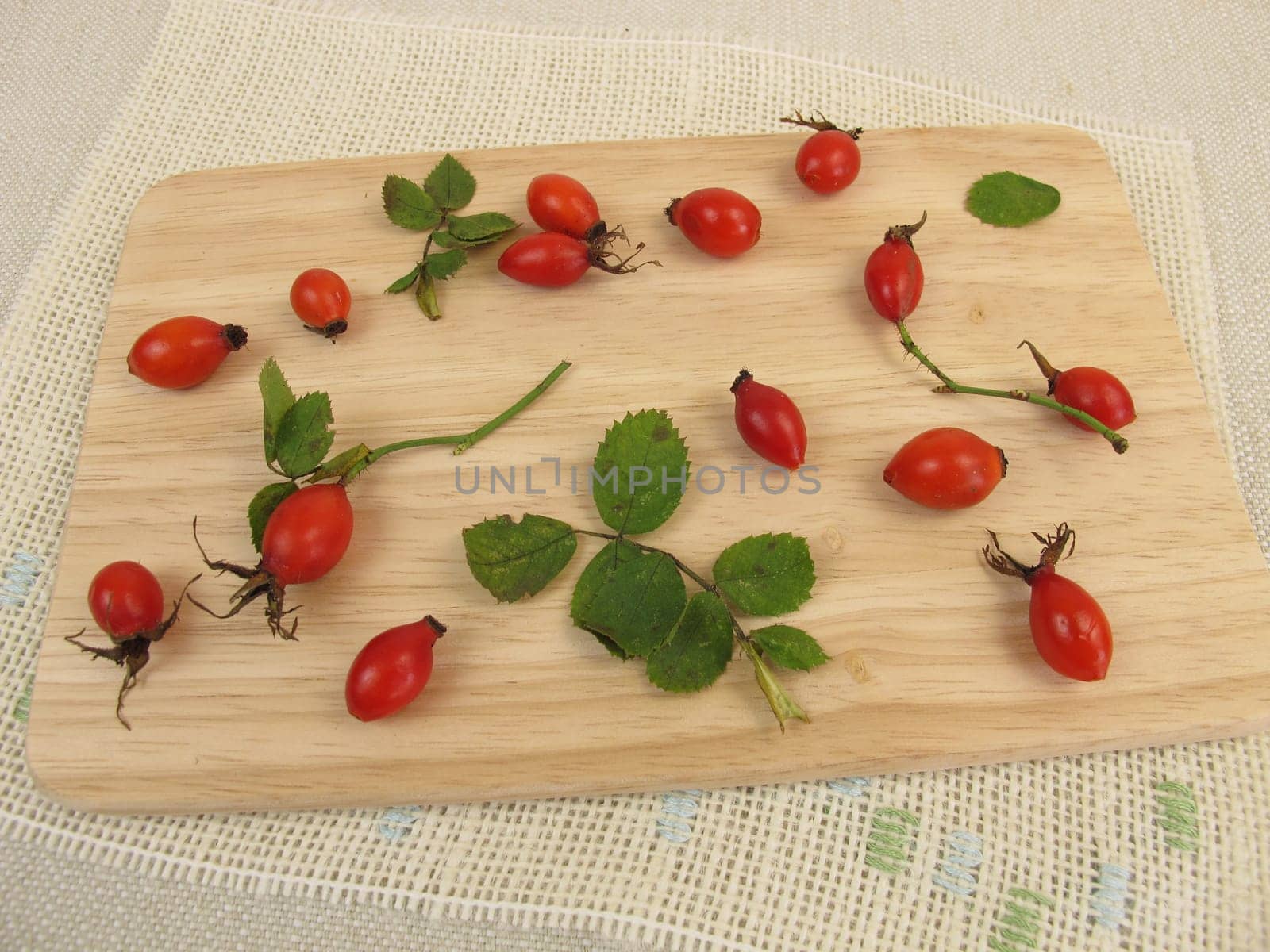 Wild fruits rose hips on a wooden board