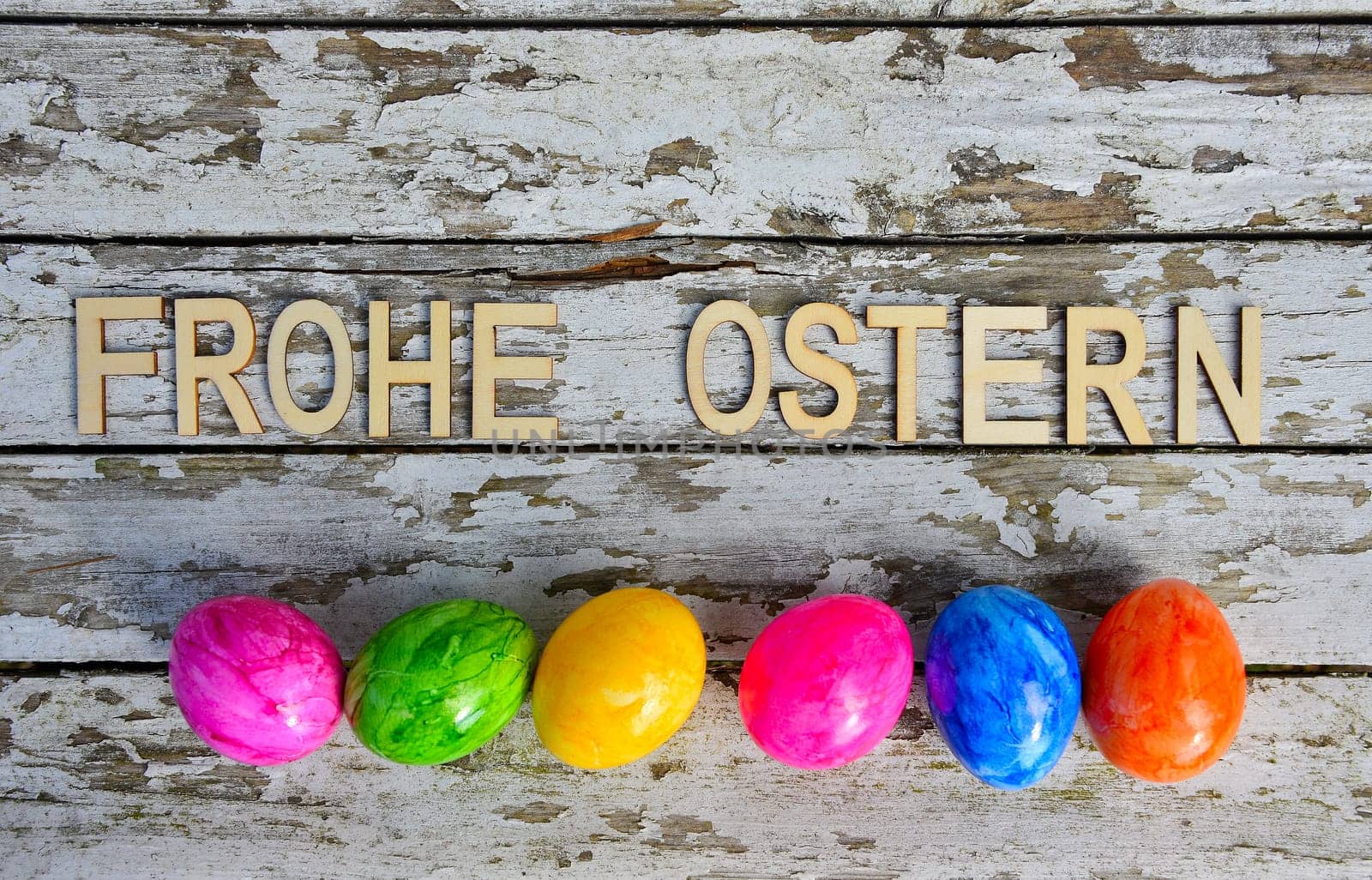 Easter bells and Easter eggs on old white wood background