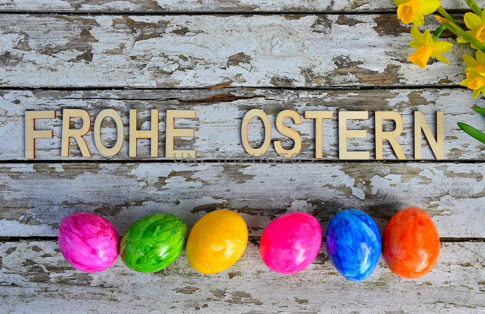 Easter bells and Easter eggs on old white wood background
