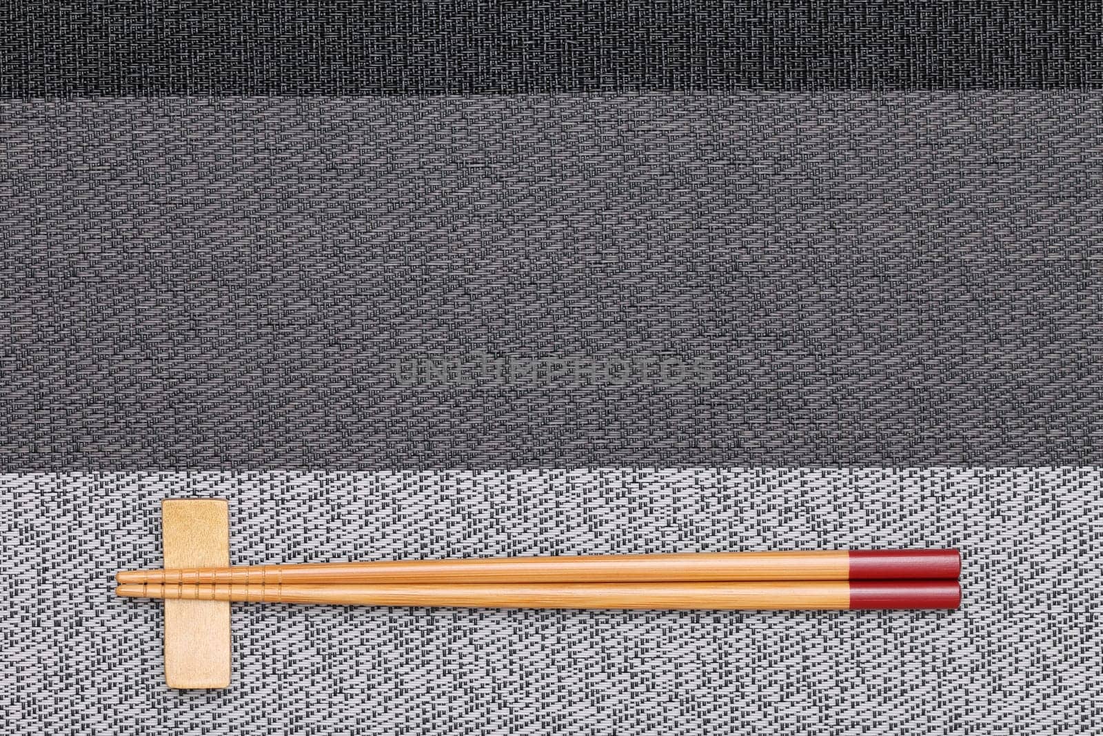Chopsticks and chopsticks rest on table background