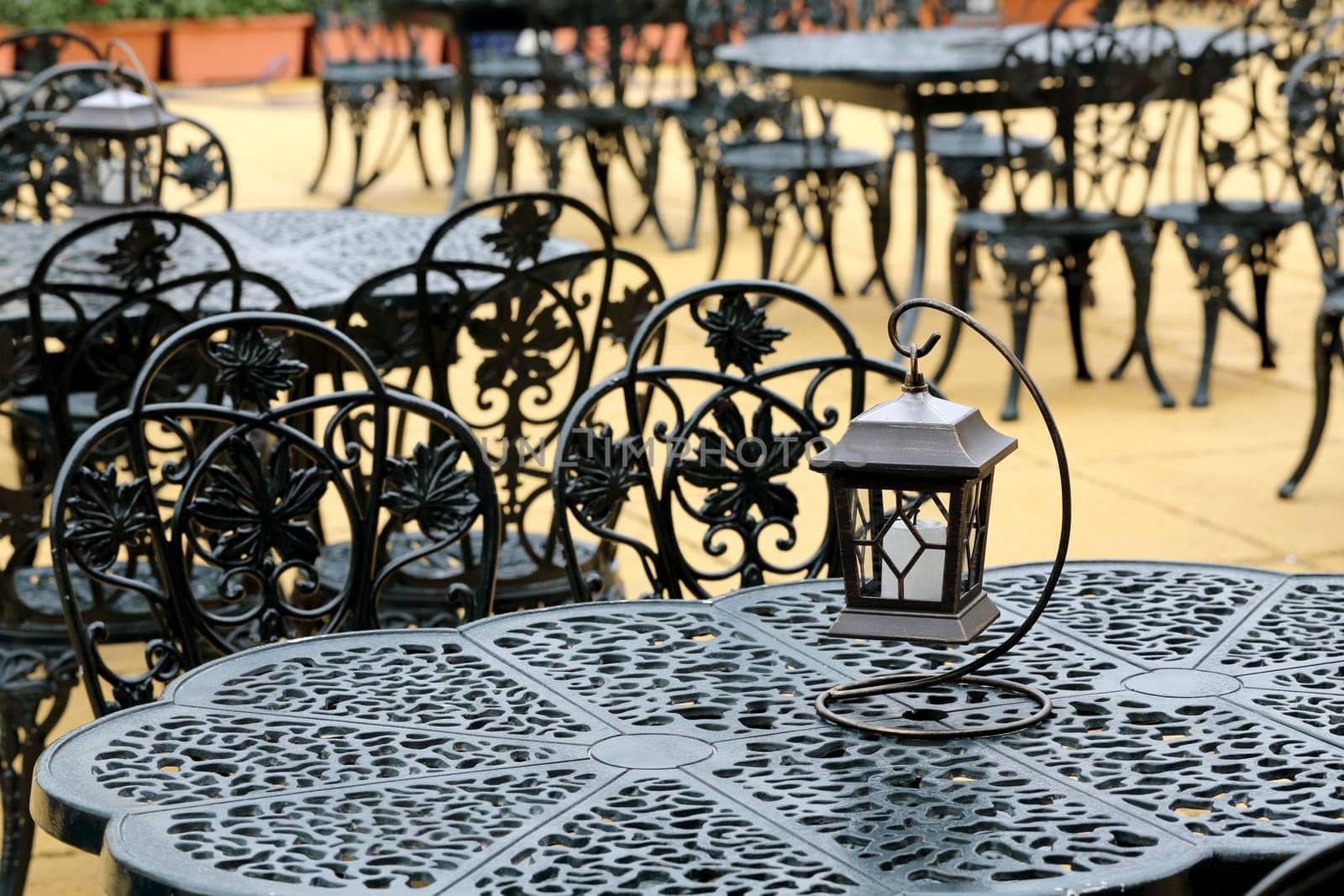 chairs and table with old lantern