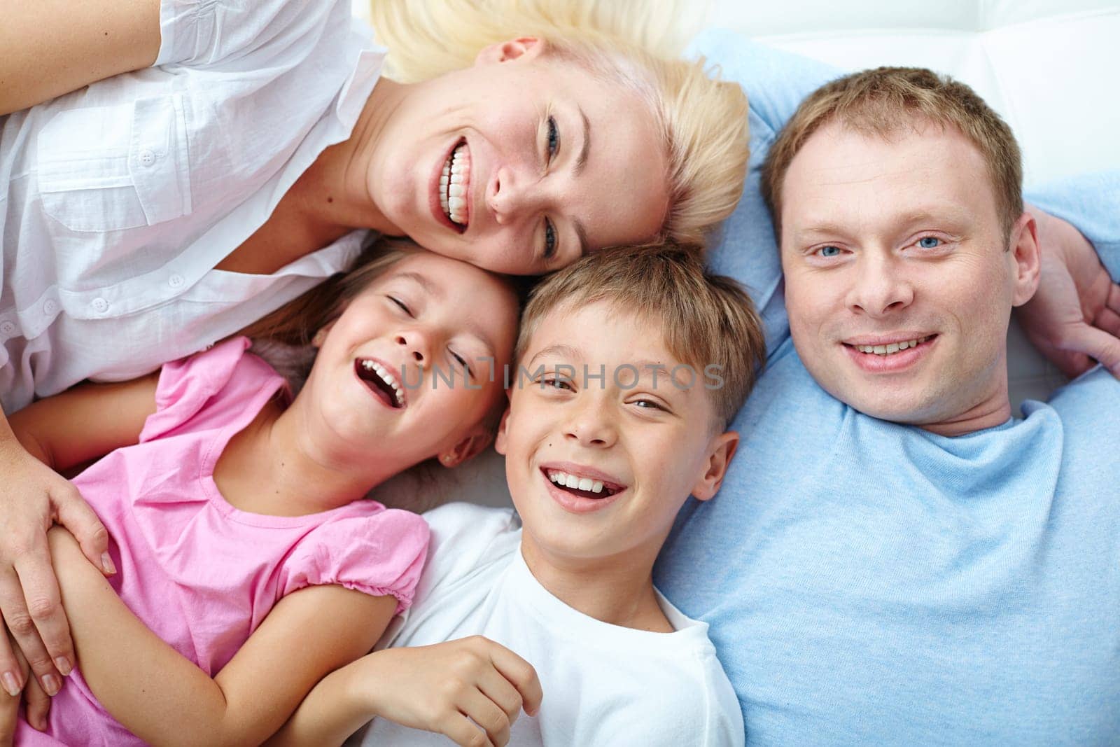 Young couple and two cute children laughing