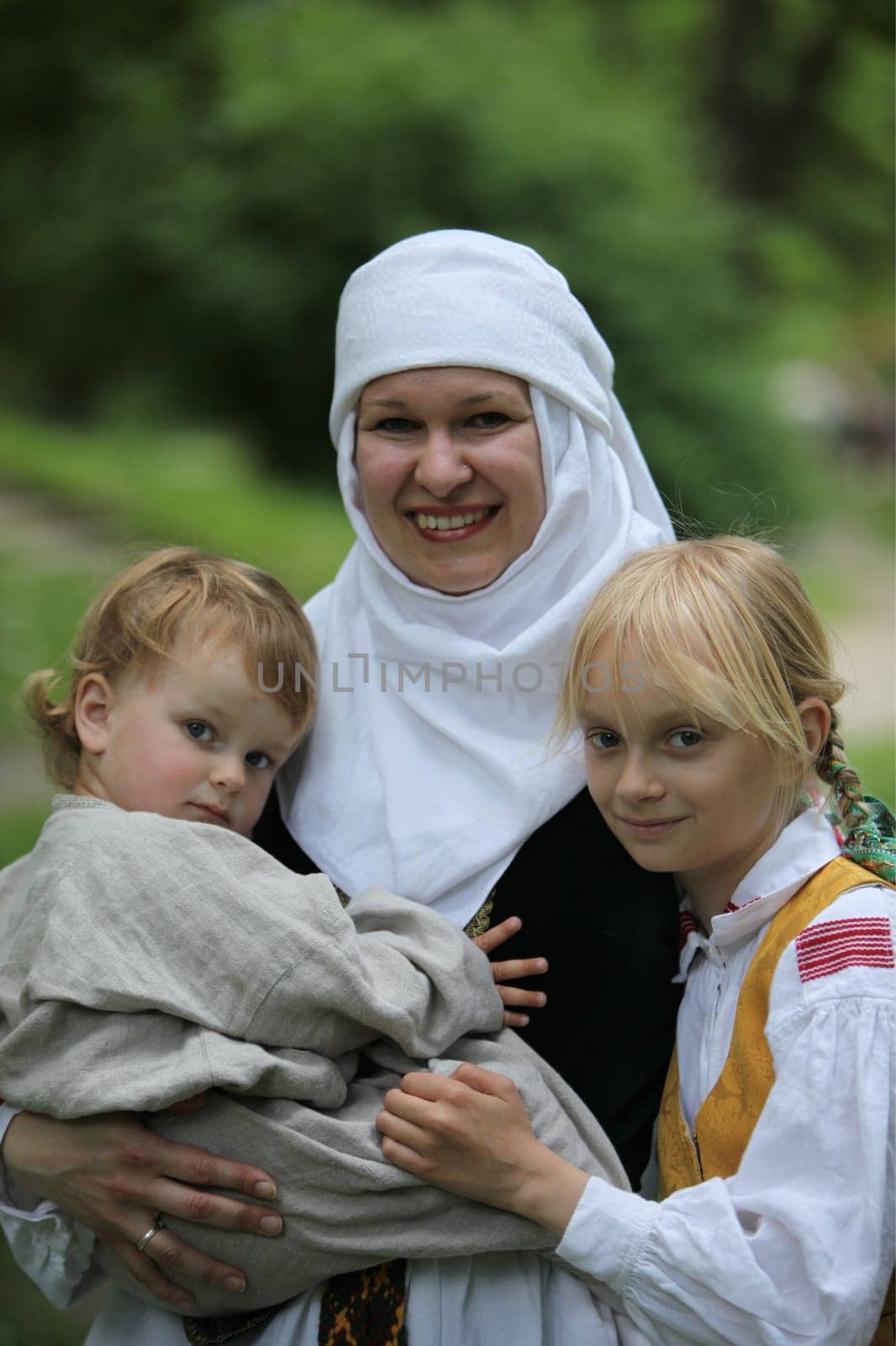 a Women in traditional dress on a Summer Festival in a Parc in the old City of Vilnius in the Baltic State of Lithuania