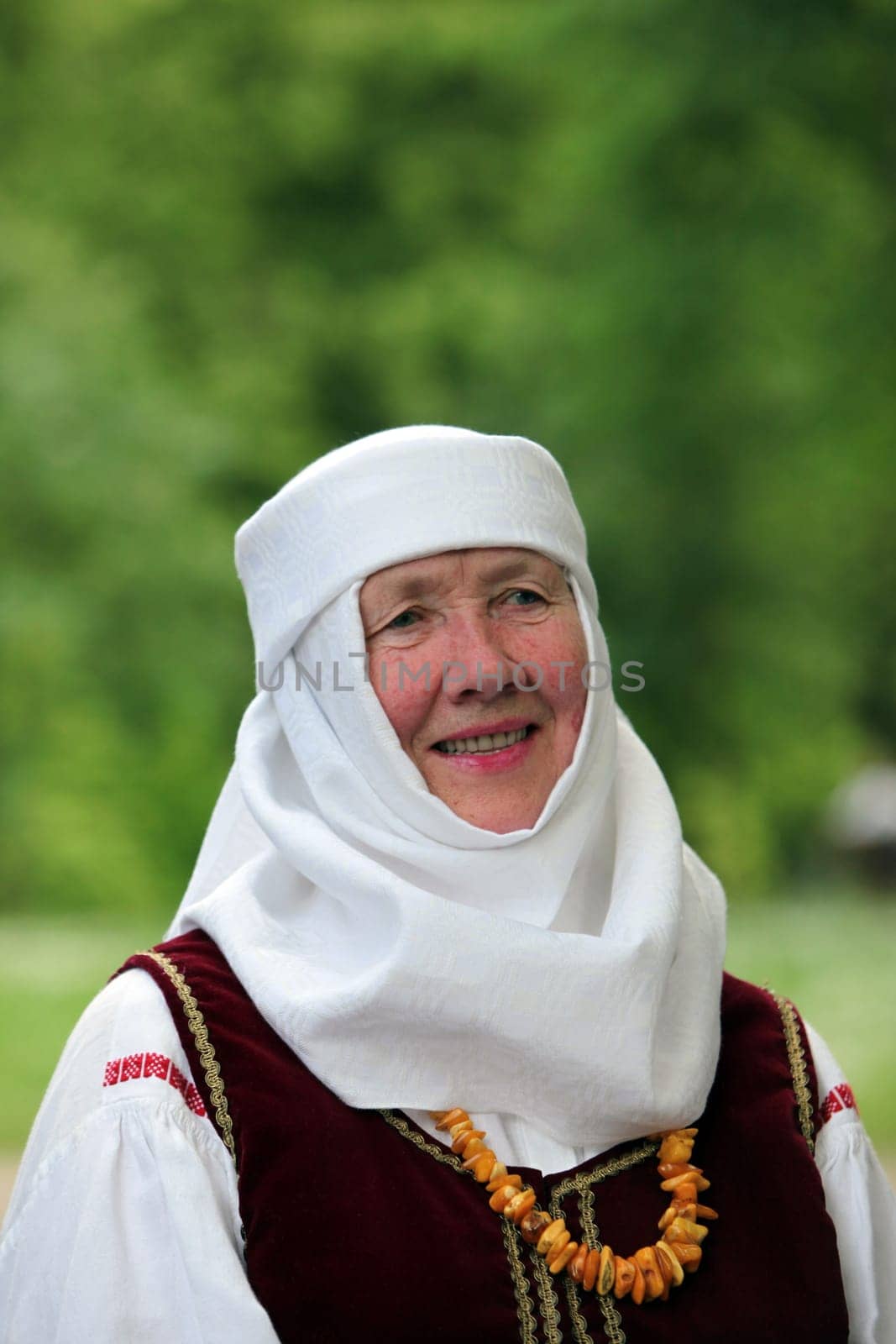 a Women in traditional dress on a Summer Festival in a Parc in the old City of Vilnius in the Baltic State of Lithuania