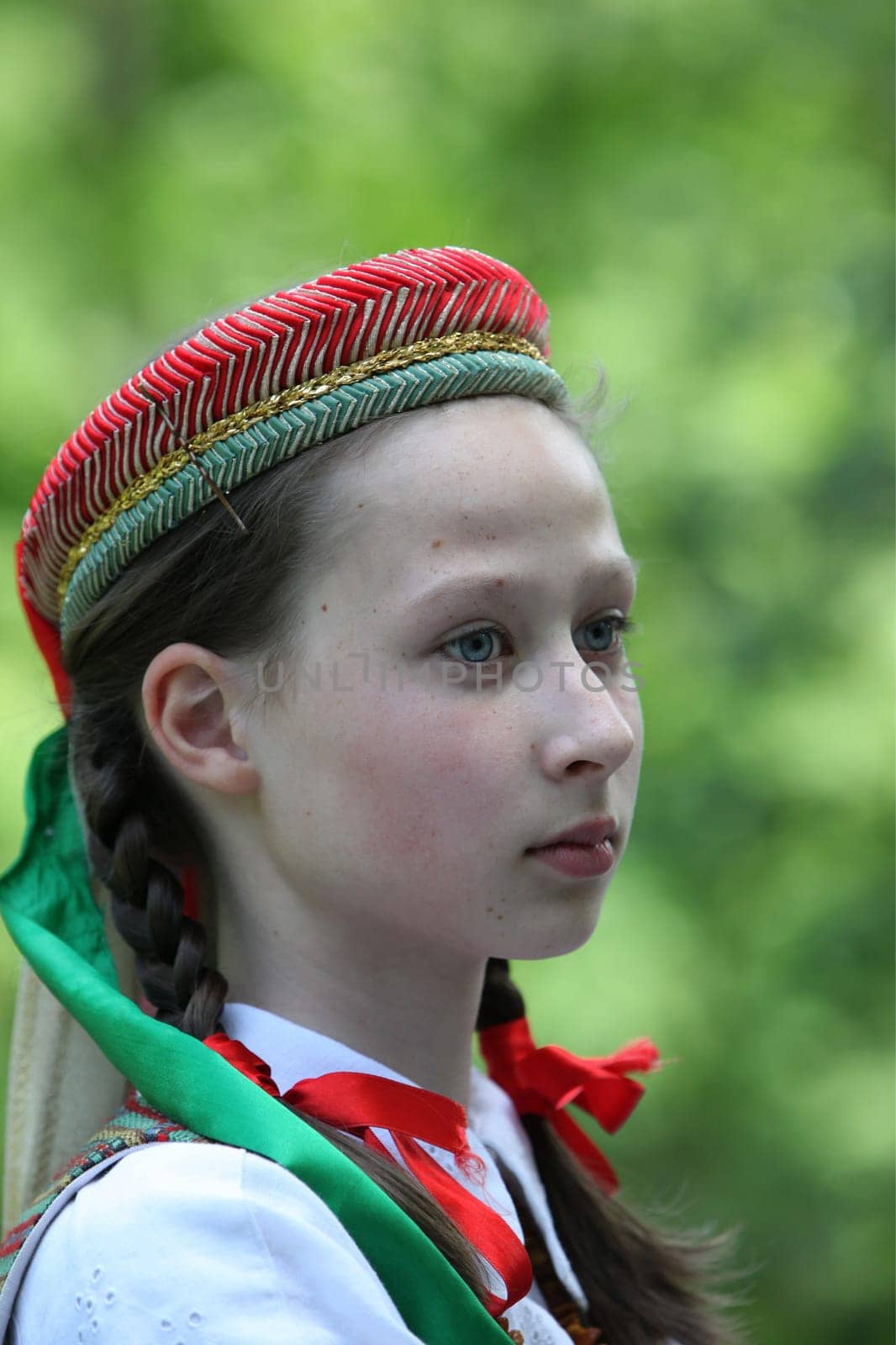 a Women in traditional dress on a Summer Festival in a Parc in the old City of Vilnius in the Baltic State of Lithuania