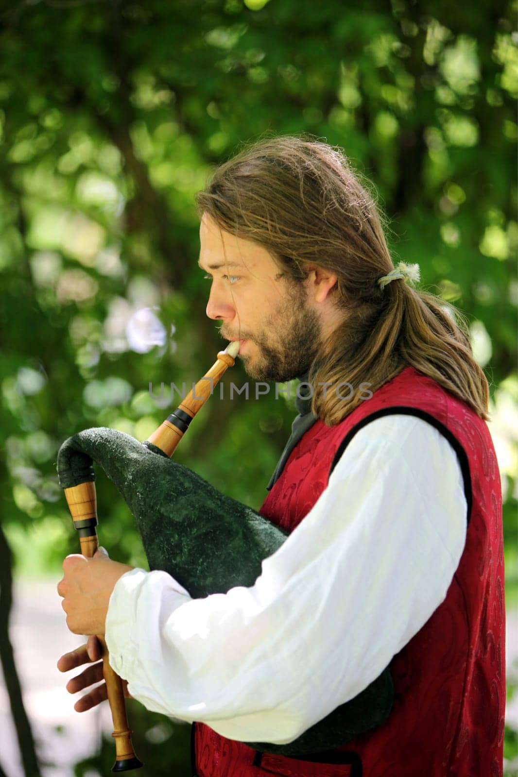 a men in traditional dress on a Summer Festival in a Parc in the old City of Vilnius in the Baltic State of Lithuania