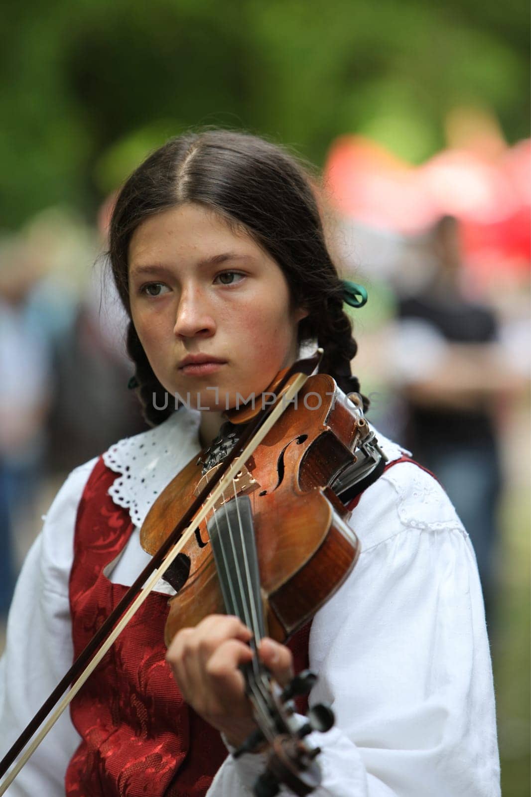 a Women in traditional dress on a Summer Festival in a Parc in the old City of Vilnius in the Baltic State of Lithuania