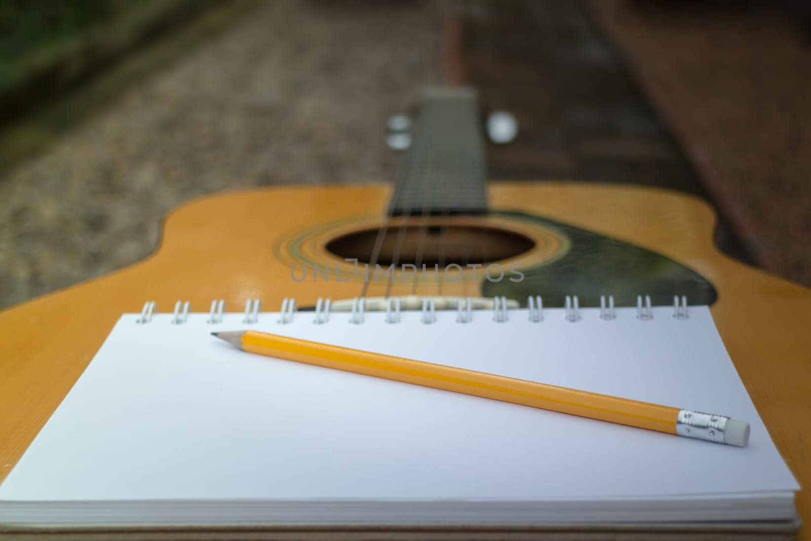 Yellow Acoustic Guitar On Wooden Table, stock photo
