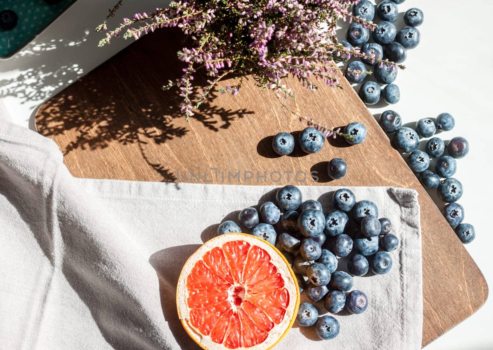 still life top view blueberries red grapefruit and violet flower