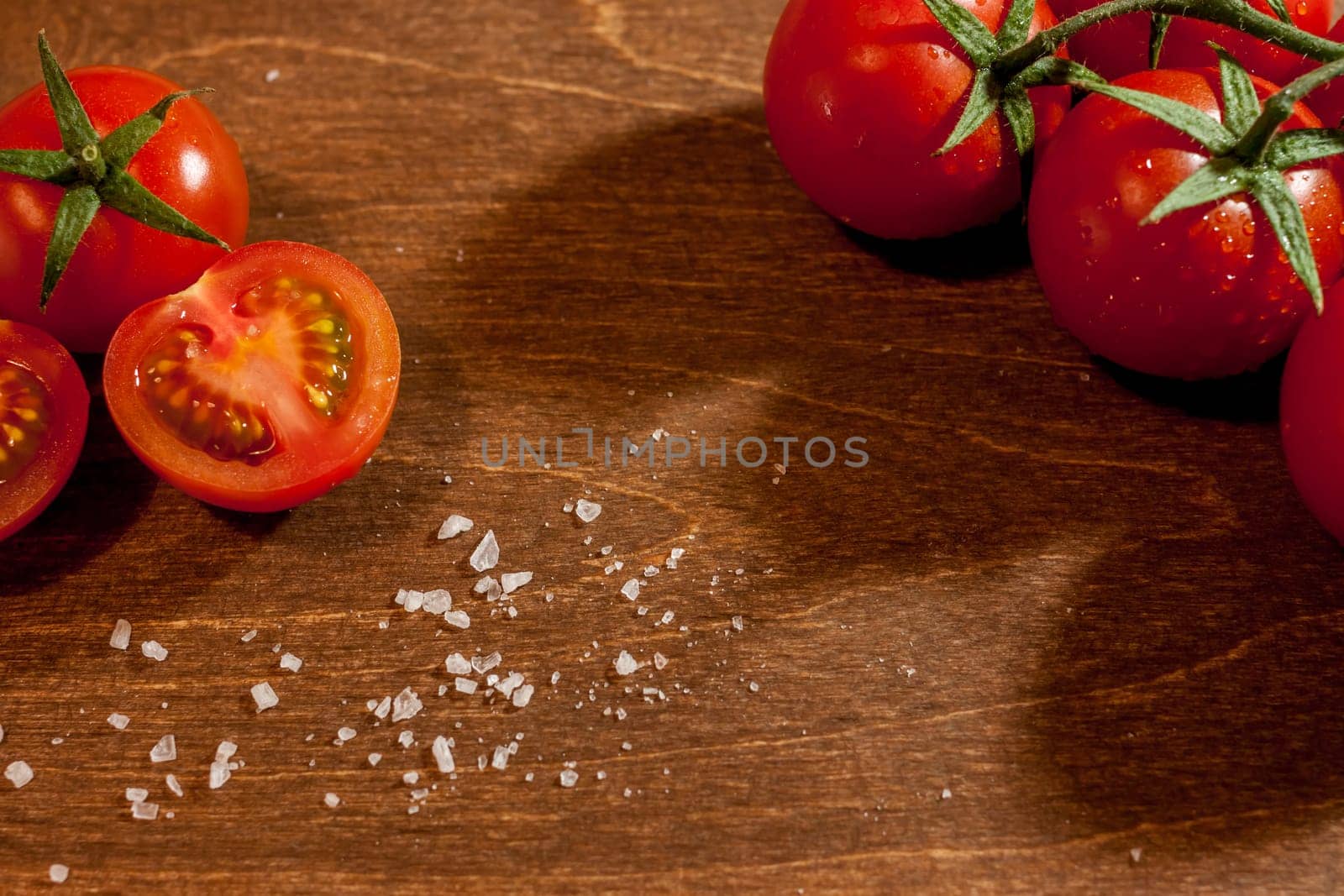 fresh ripe cherry tomatoes on wooden background salt free space