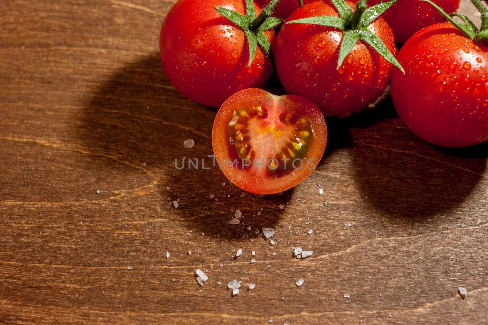 fresh ripe cherry tomatoes on wooden background salt free space