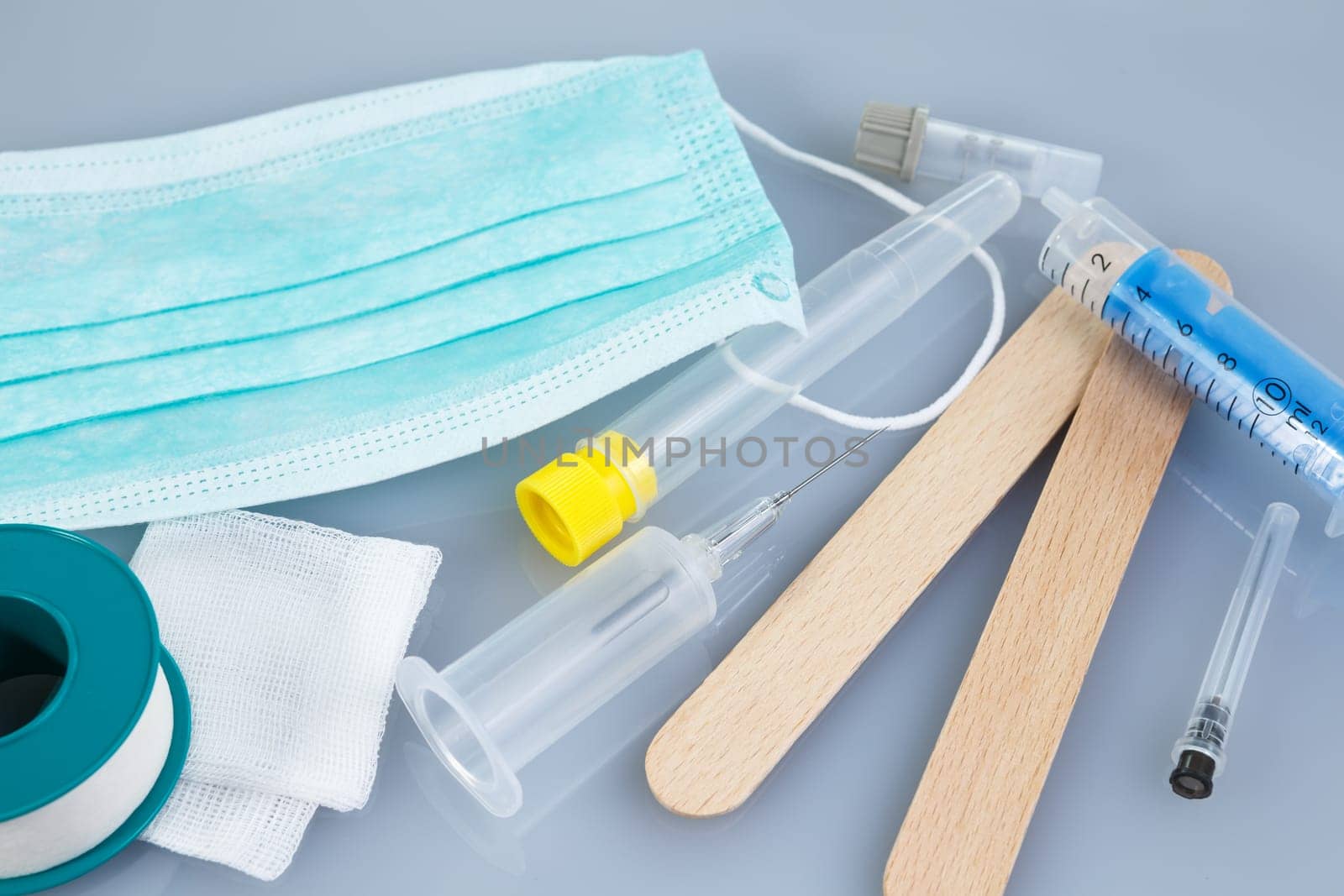 Syringes and needles and other medical items. Healthcare or pharmacy themes.