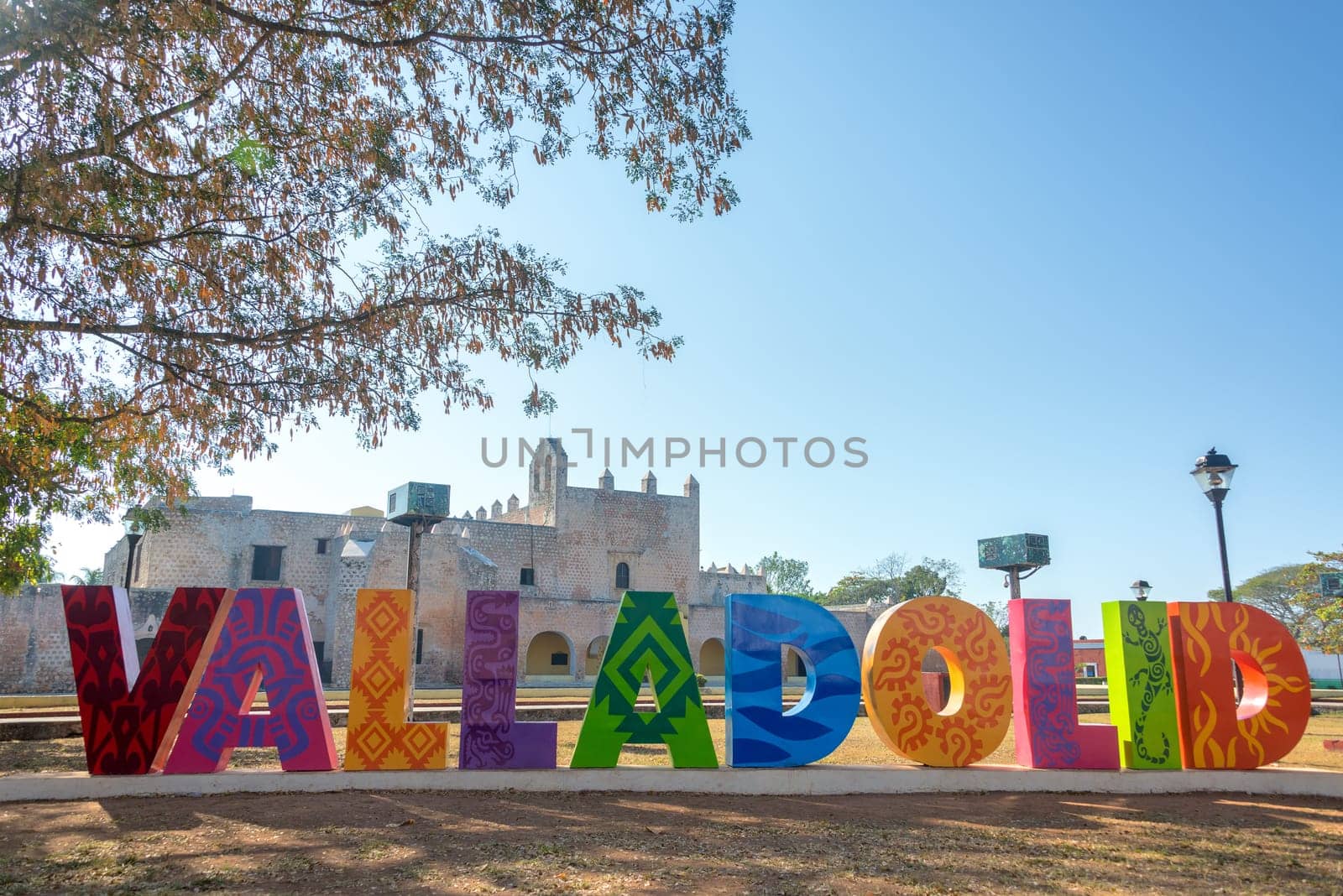 Sign for Valladolid, Mexico with the Convent of San Bernardino in the background