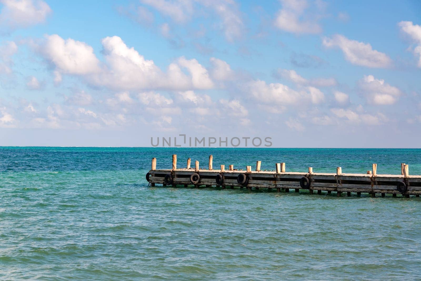 View of a pier extending out into the Caribbean Sea in Punta Allen in the Sian Kaan Biosphere Reserve near Tulum, Mexico