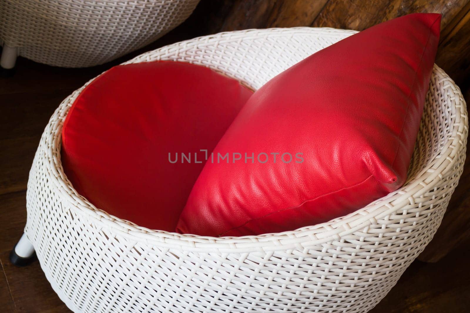 Red Pillow With Plastic Rattan Furniture, stock photo