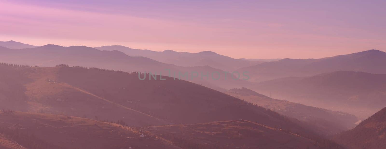 Beautiful pink morning sunrise in the mountain landscape. Carpathians, Western Ukraine, Europe. Panorama photo.