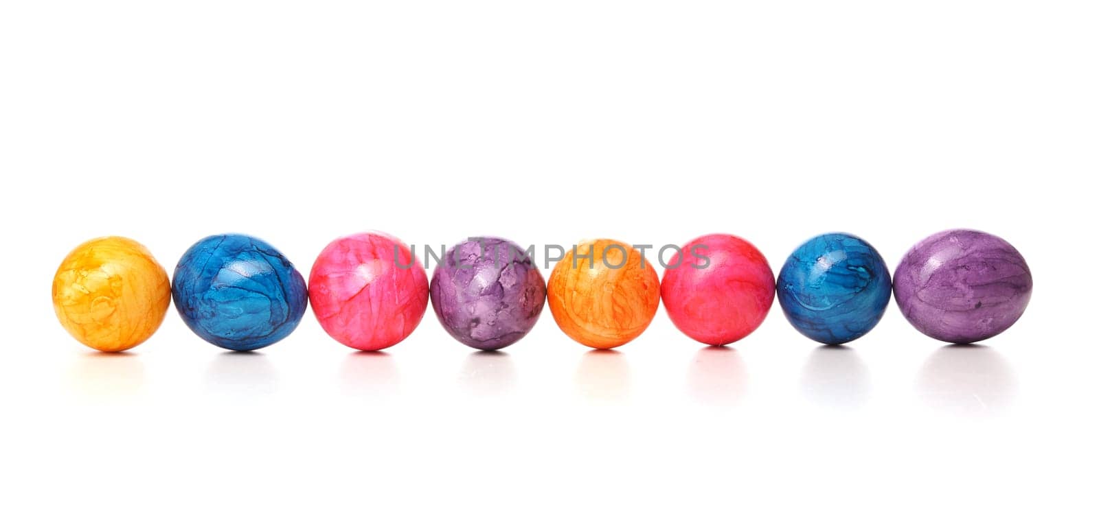 Eight colored eggs in a row on a white background, Easter header or background