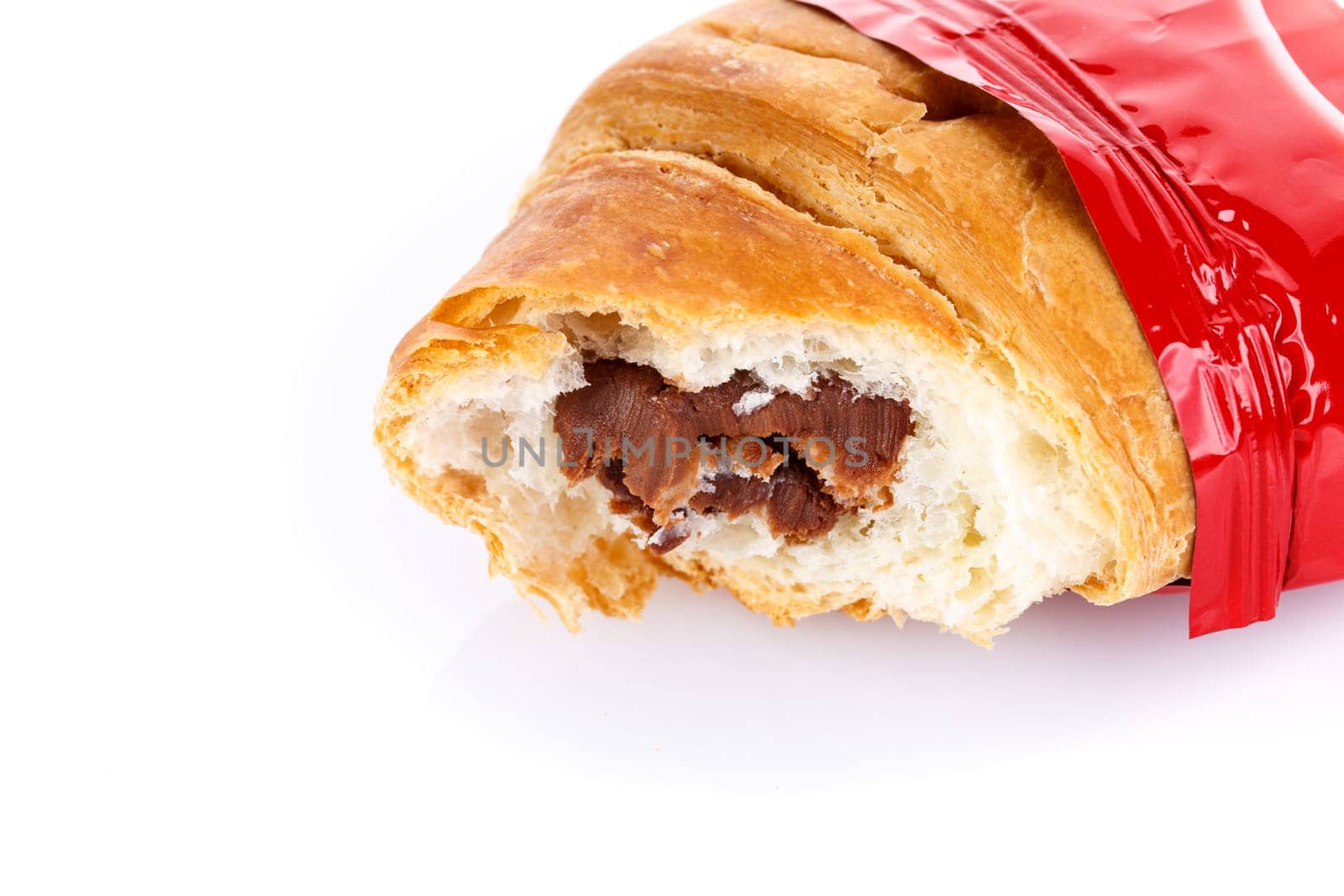 Bitten fresh Croissant with chocolate filling on white background