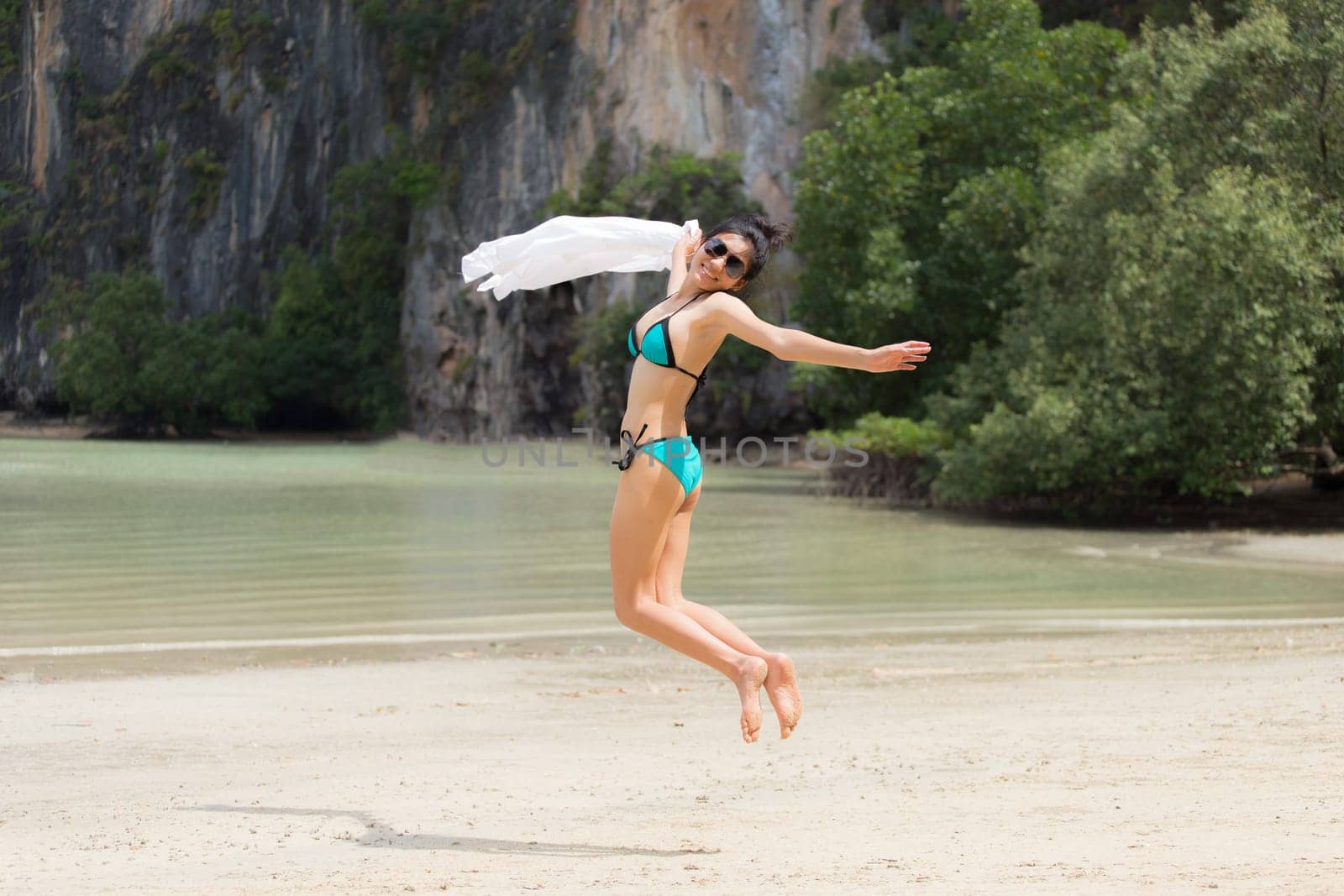Beautiful young girl on tropical island beach