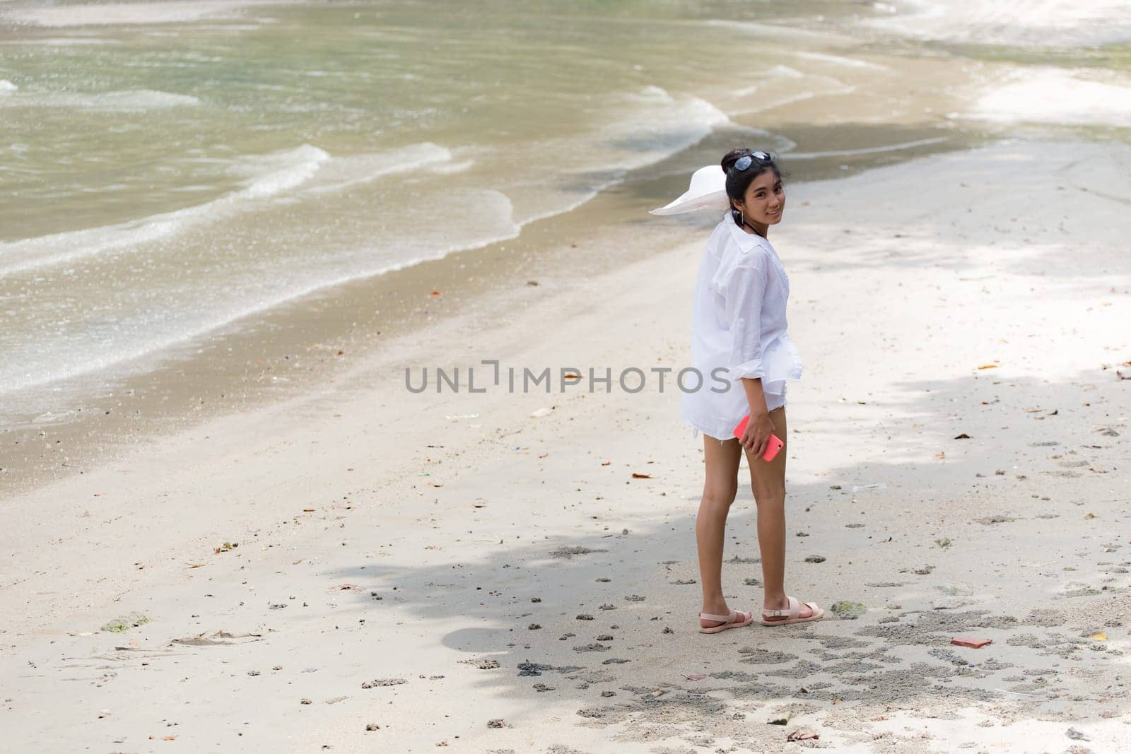 Beautiful young girl on tropical island beach