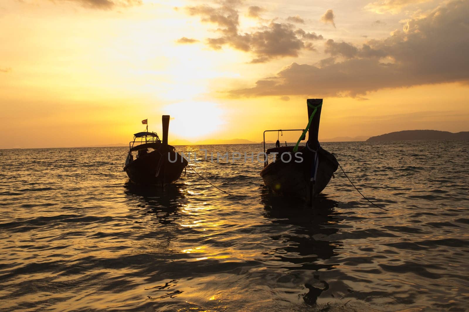 Traditional thai longtail boat at sunset on the Beach. Thailand, Krabi province
