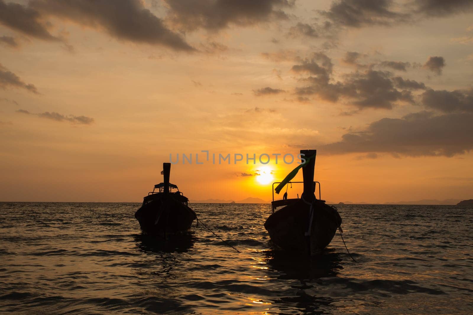 Traditional thai longtail boat at sunset on the Beach. Thailand, Krabi province