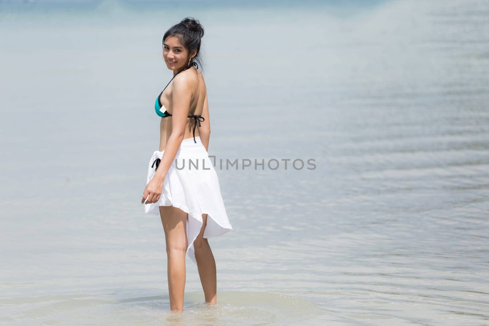 Beautiful young girl on tropical island beach