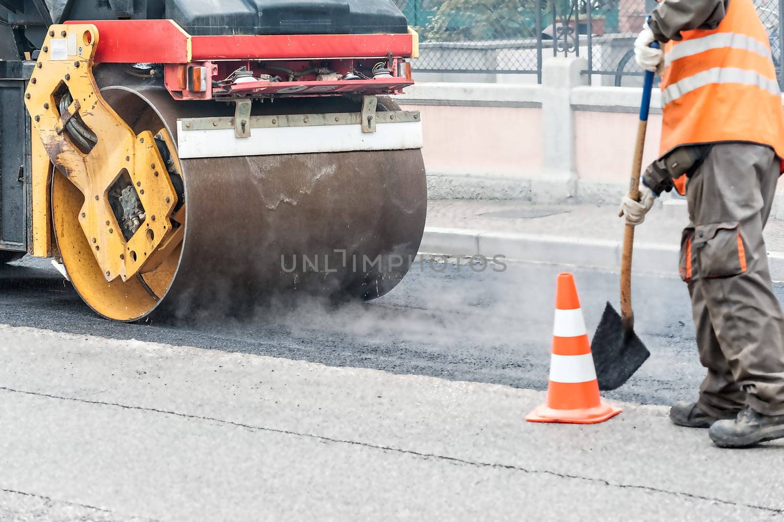 Road roller at work. Work of asphalting a road.