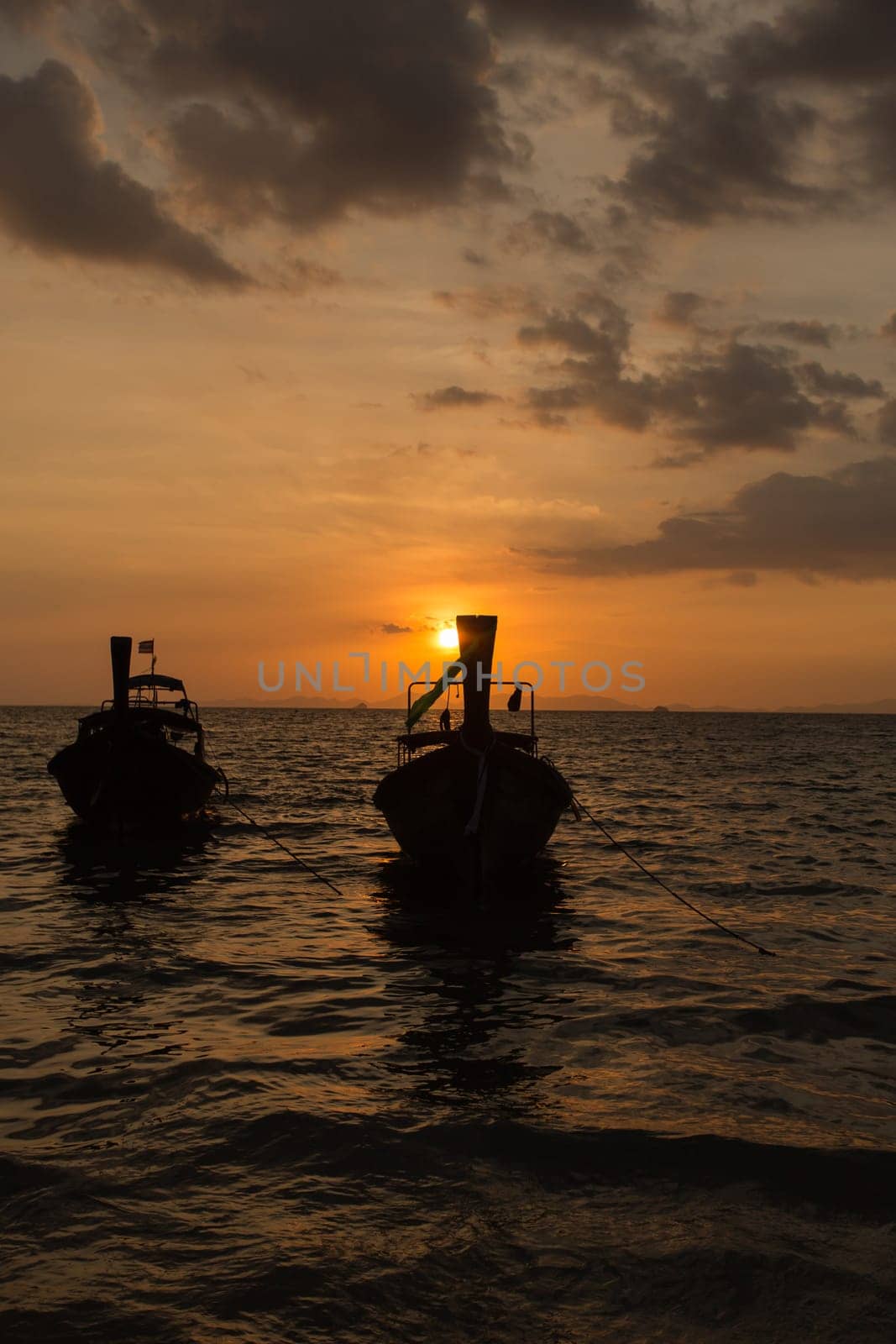 Traditional thai longtail boat at sunset on the Beach. Thailand, Krabi province