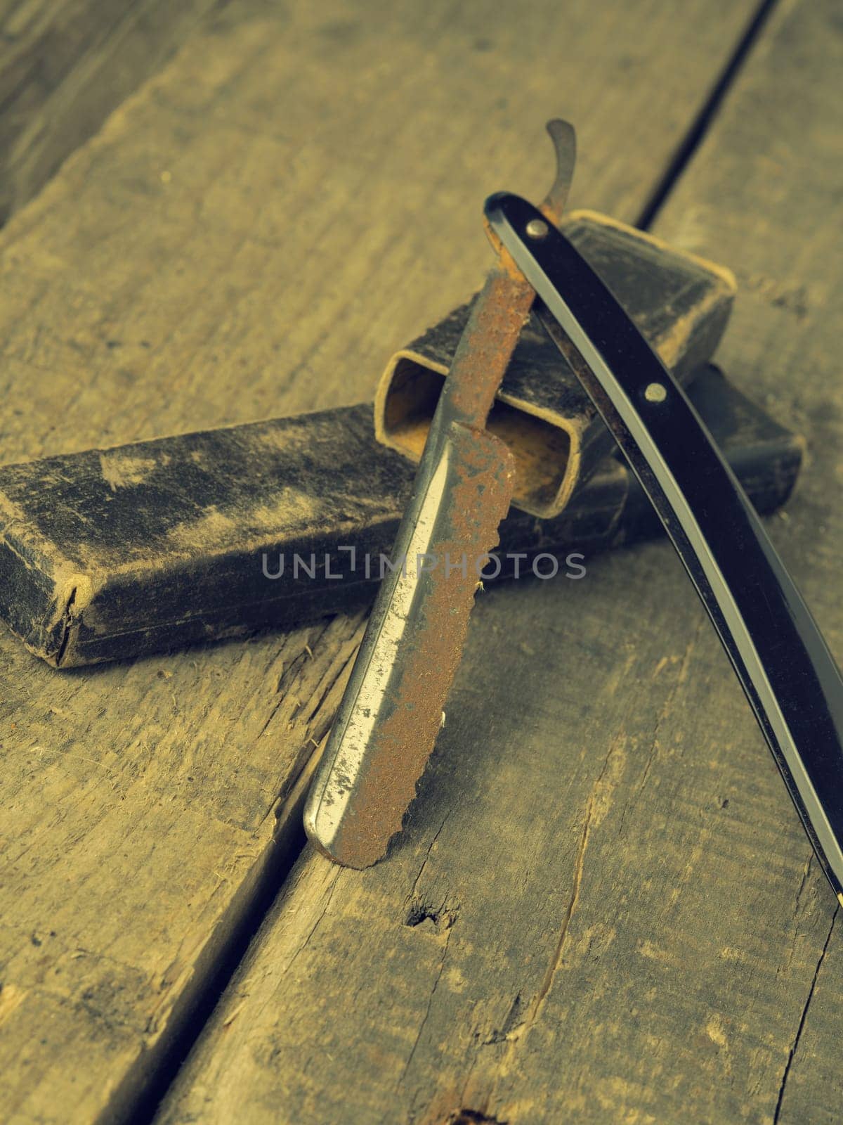 Old and rusty razor on a rustic workbench with space for text or image