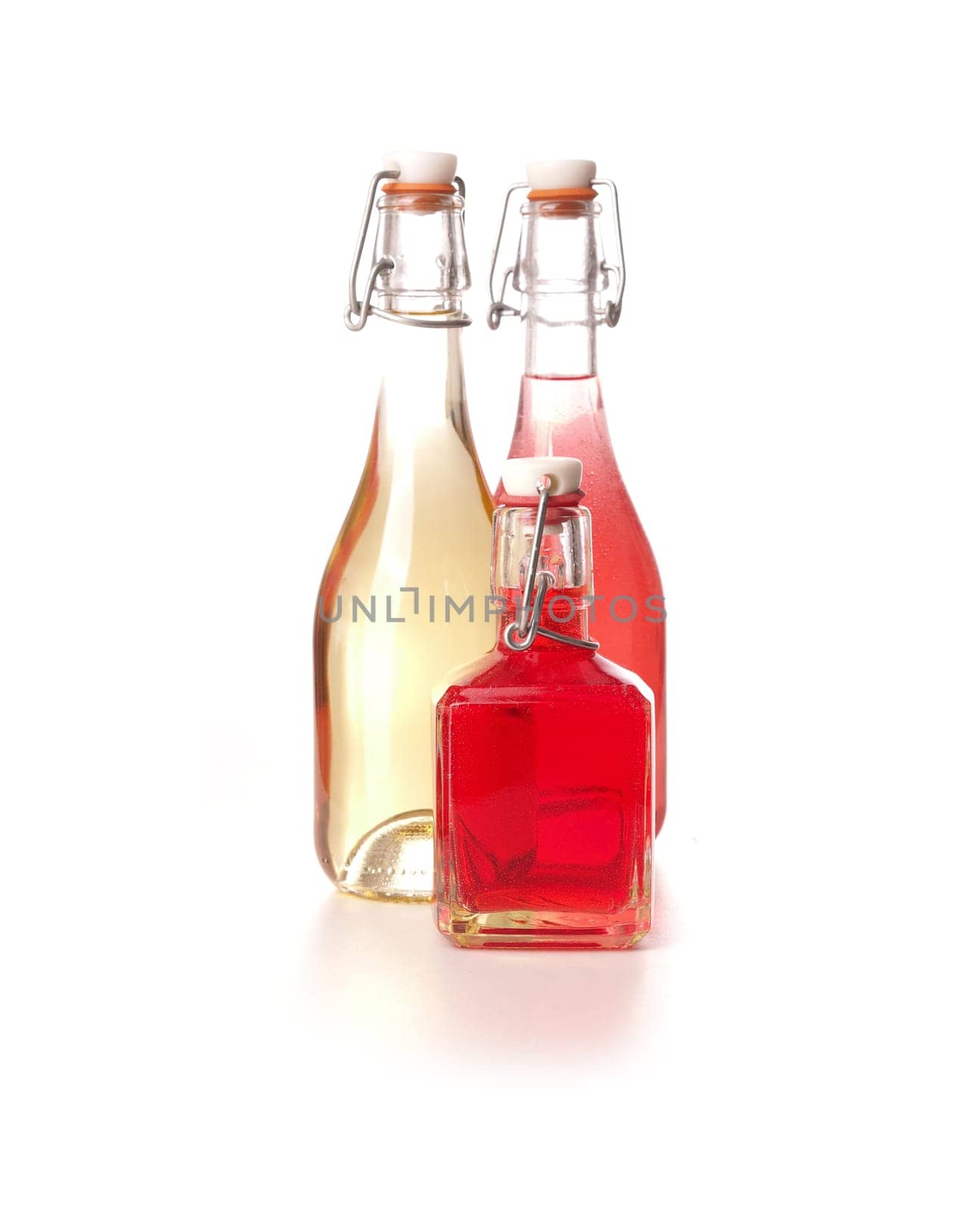 Three bottles of juice on a white background