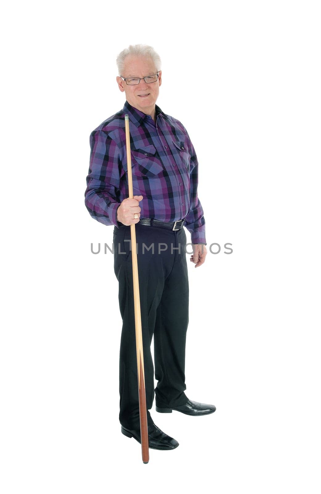 A handsome senior citizen man in a checkered shirt and jeans standing.with a billiard cue isolated for white background..