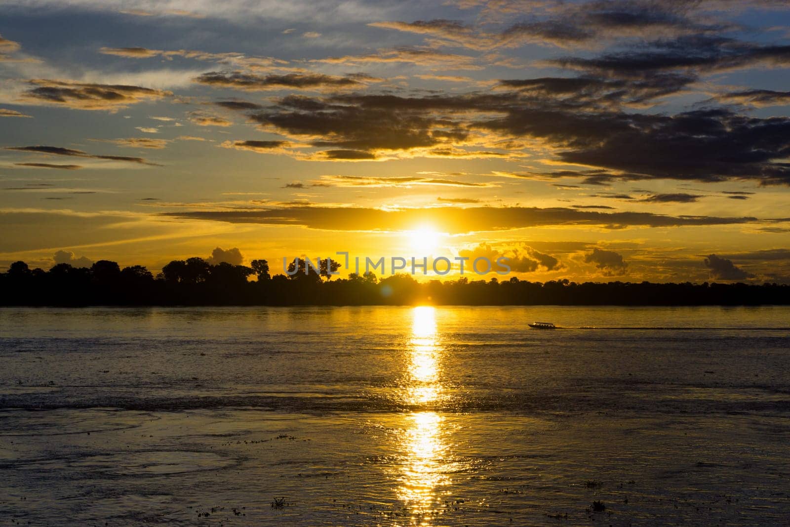 Boat on the Amazon River at sunset near Leticia, Colombia