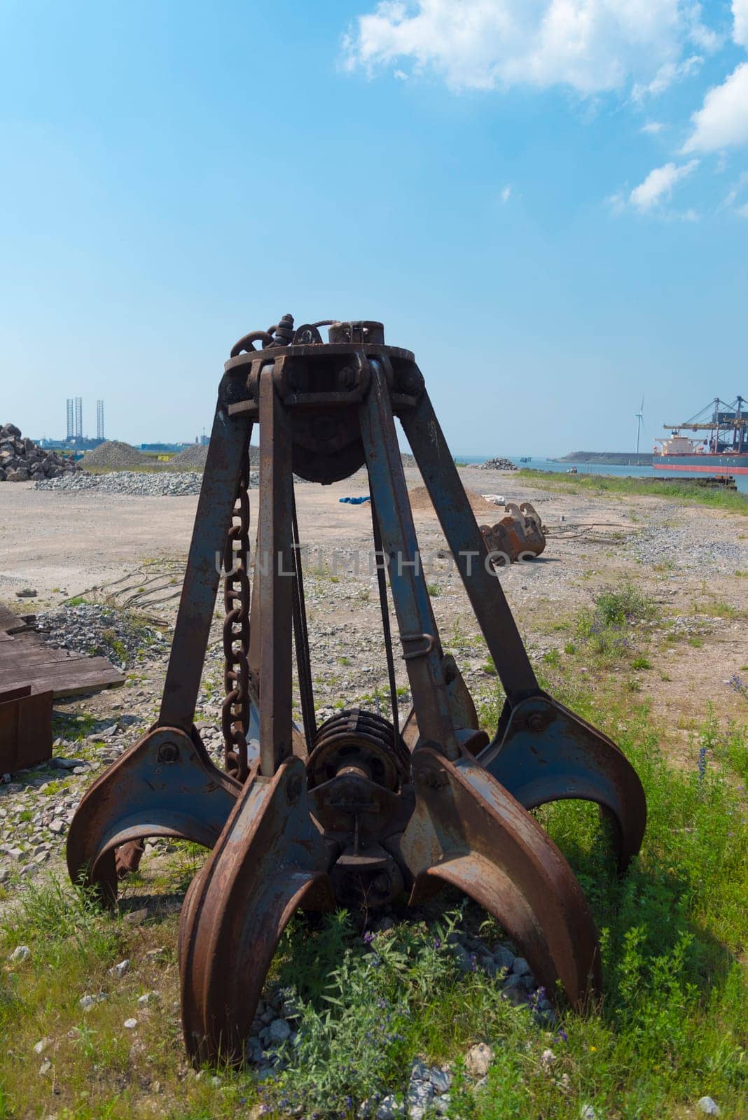 left behind rusty iron stone grabber