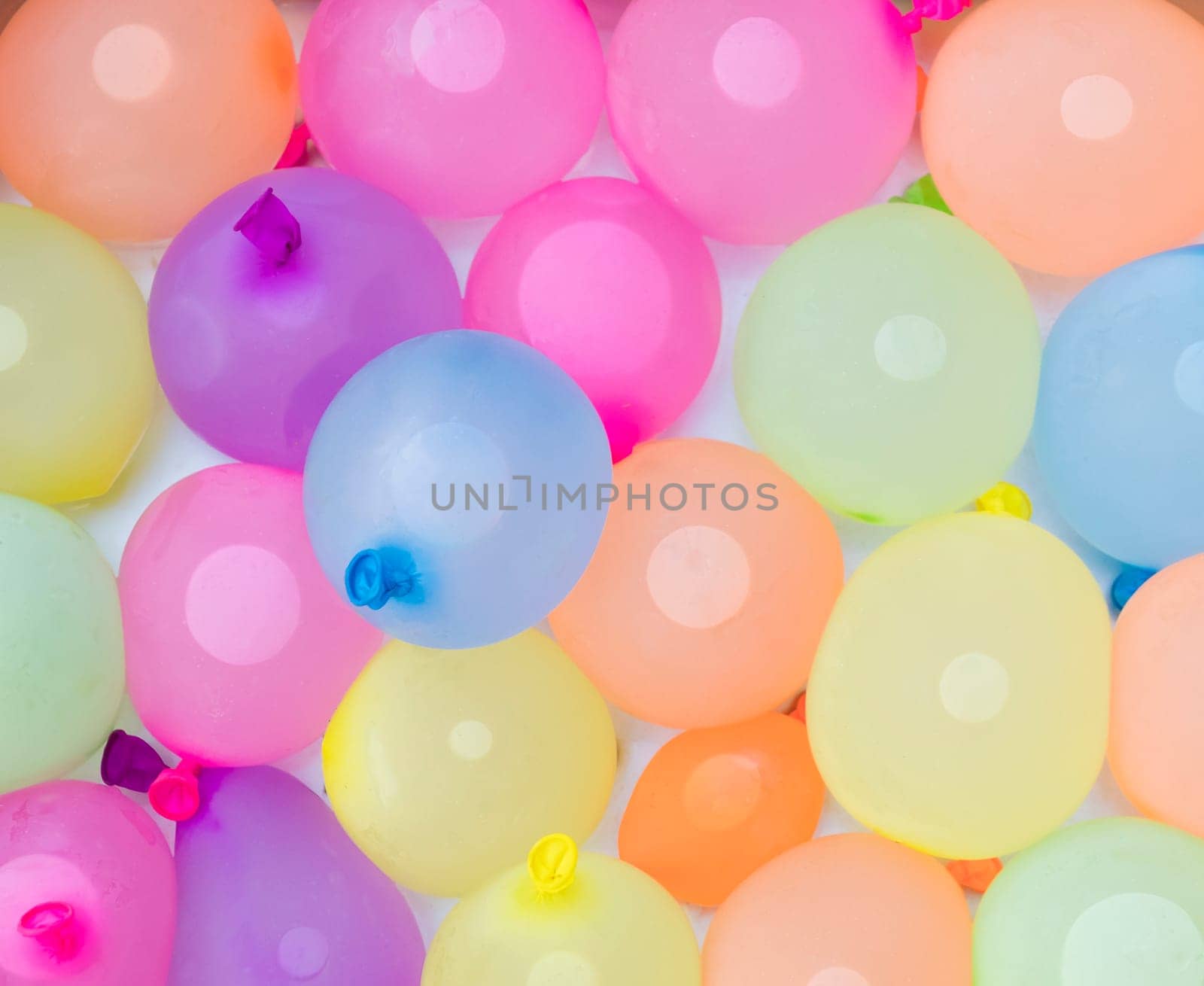 background of colorful water balloons ready for action on a hot summer day