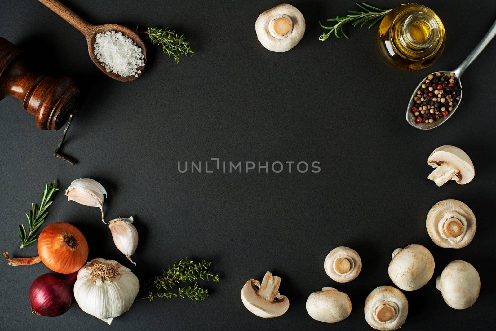 Mushrooms champignons with fresh ingredients on wooden background
