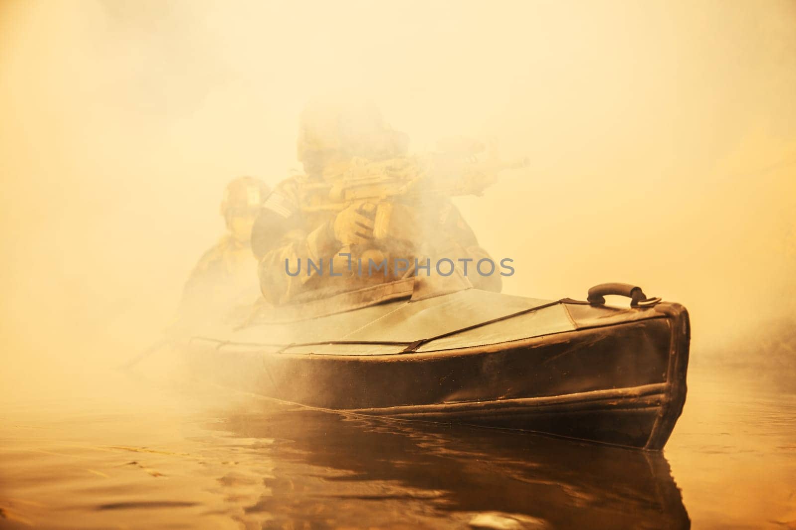 Special forces marine operators in camouflage uniforms paddling army kayak through river fog. Diversionary mission, machine gunner ahead