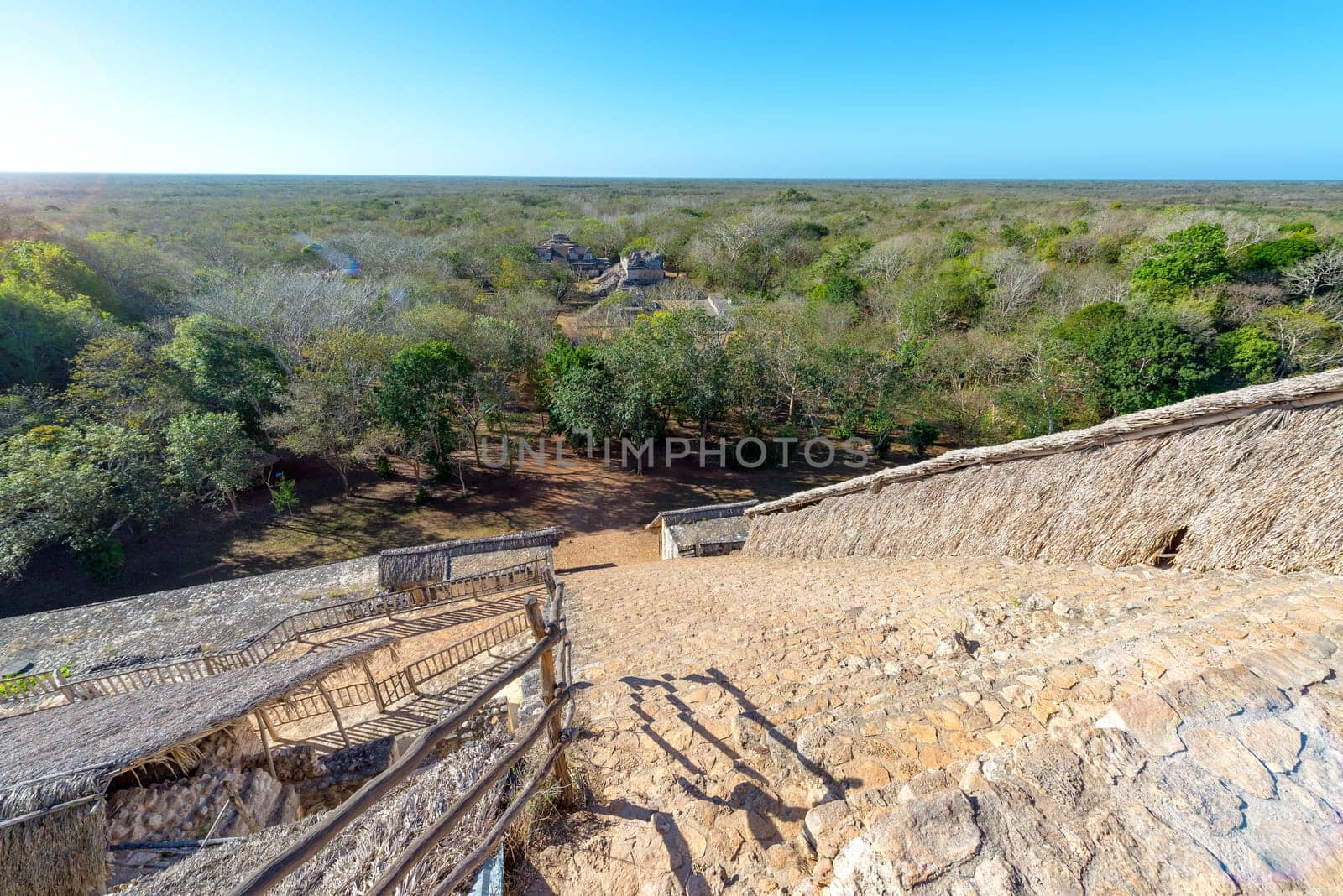 Stairs leading down the pyramid at Ek Balam with the jungle and other ruined temples visible near Valladolid, Mexico