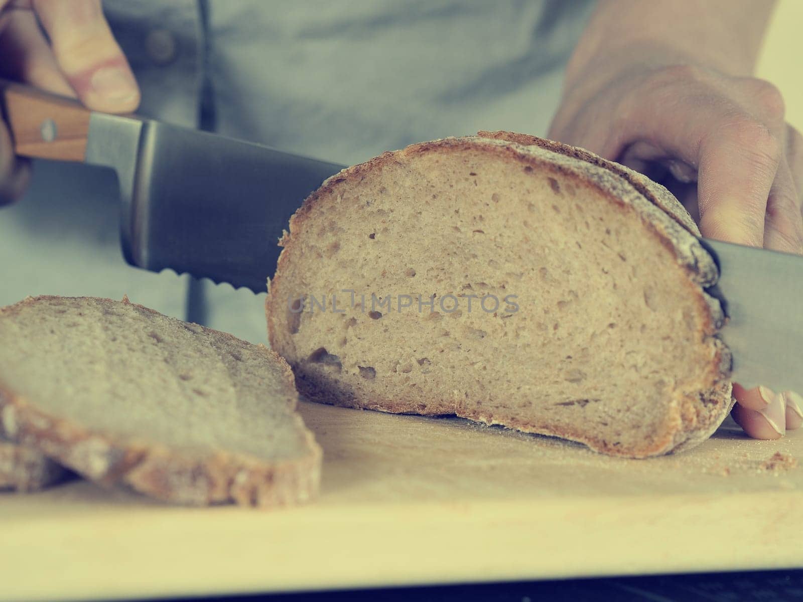 Close up shot of a man cutting bread