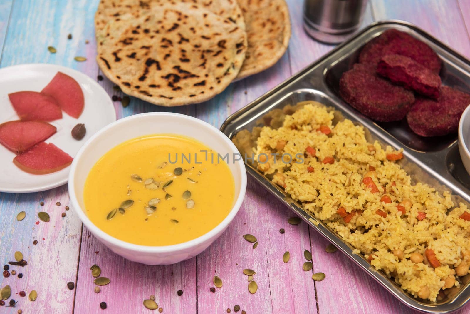 Vegetarian food: pea soup, pilaf, flat cakes, beet cutlets, pumpkin seeds and compote of pickled pears