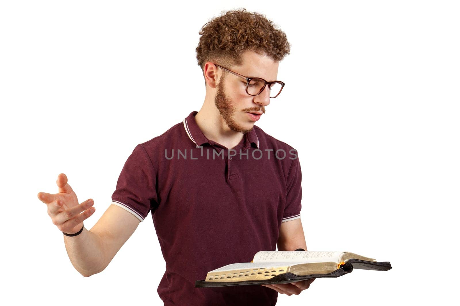 Young man reading from the Bible on white background