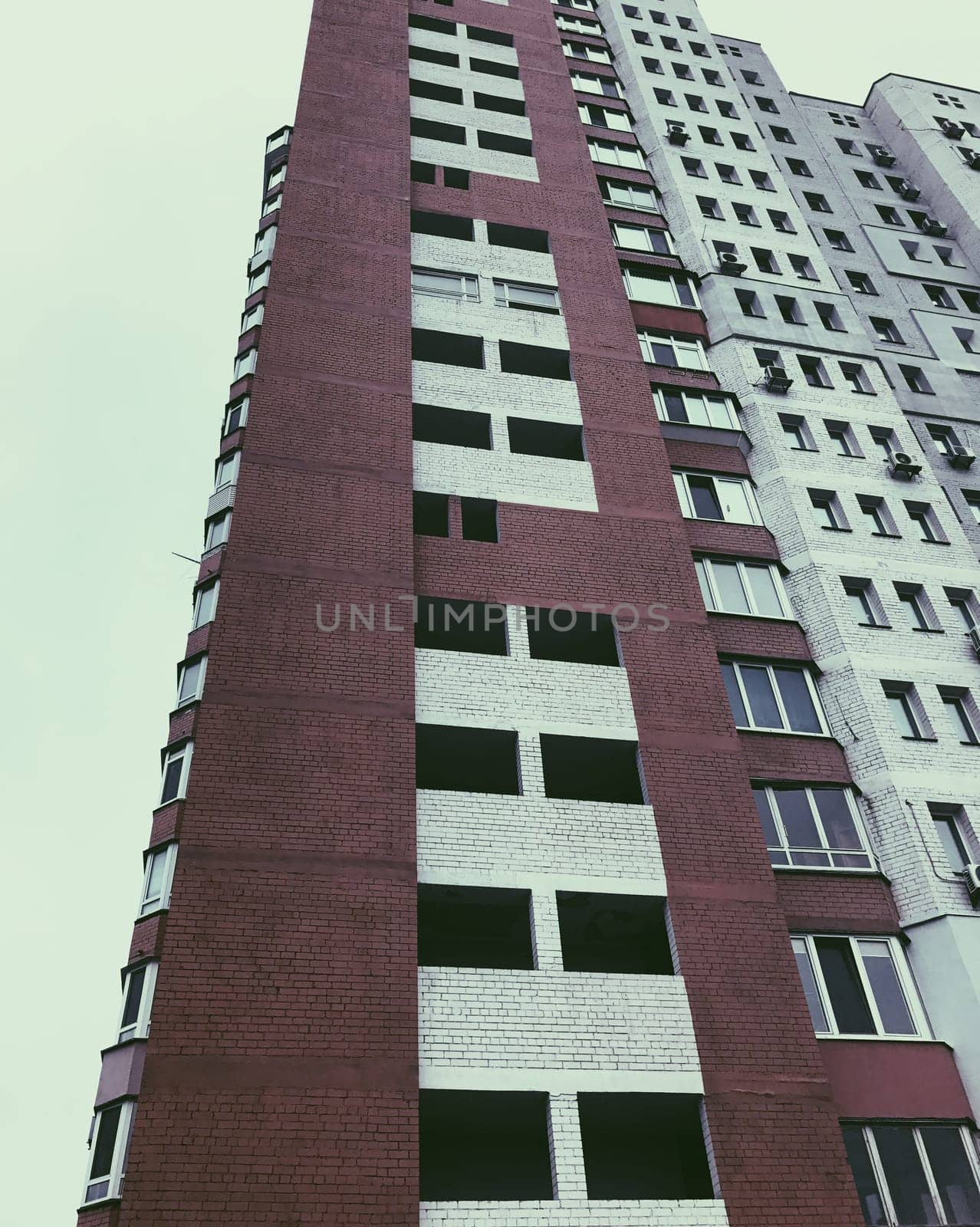Top part of high-rise business building on blue sky