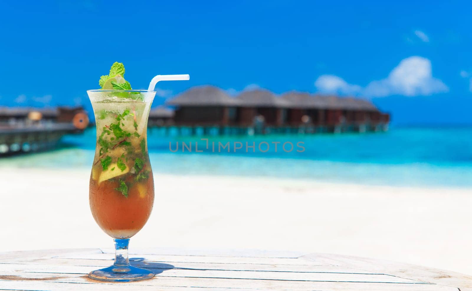 cocktail with blur beach on background..