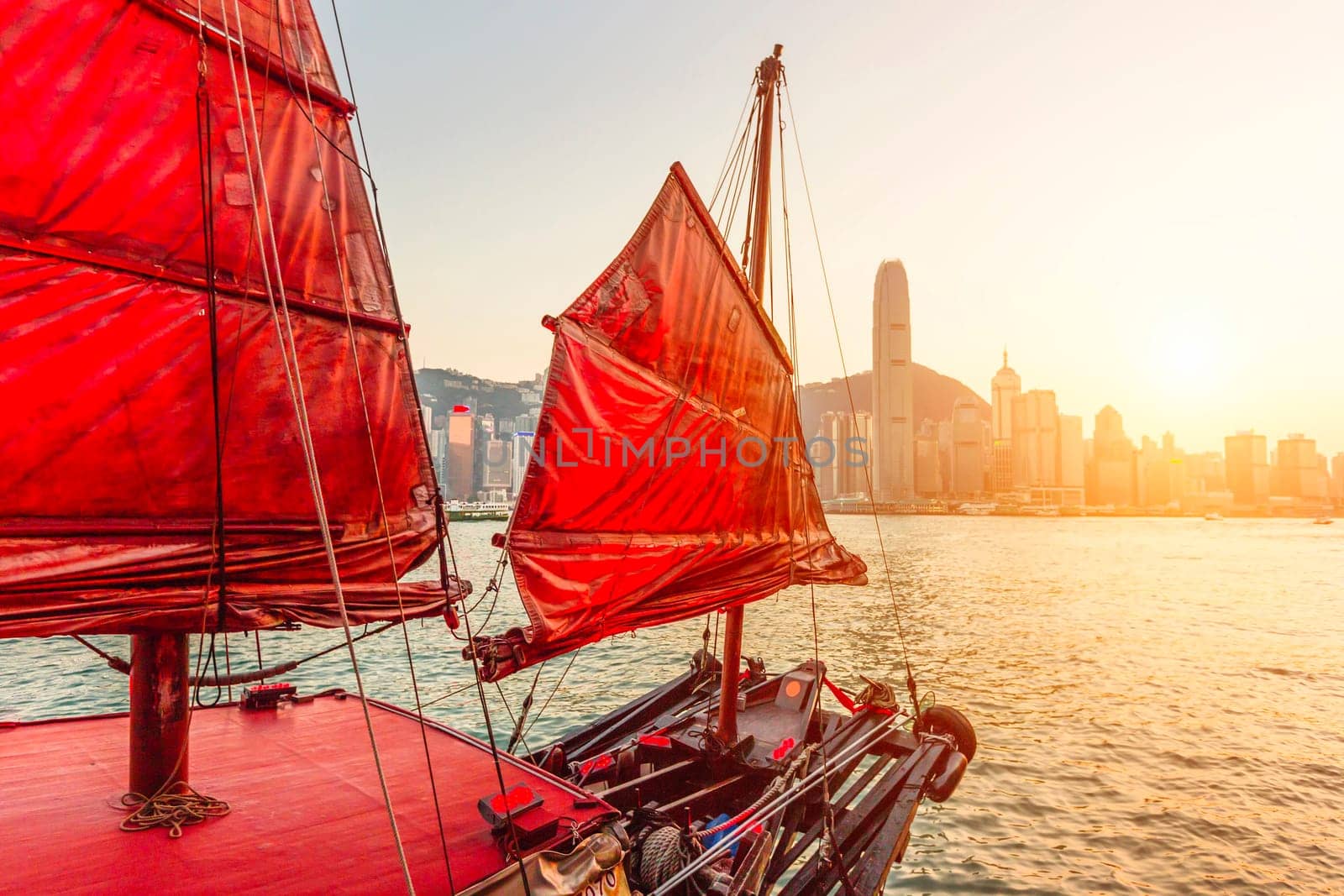 Sailboat In Hong Kong Harbour at sunset.