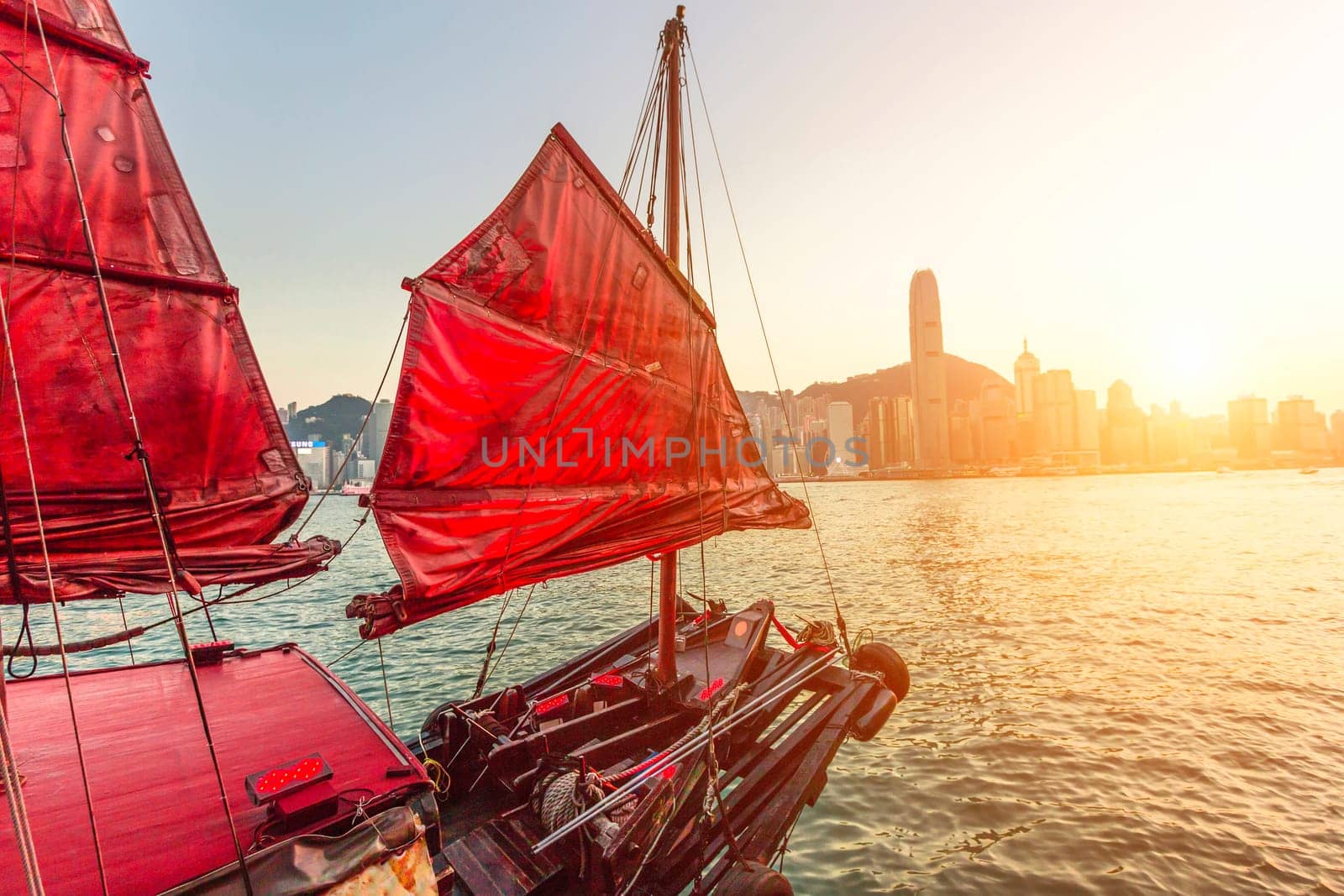 Sailboat In Hong Kong Harbour at sunset.