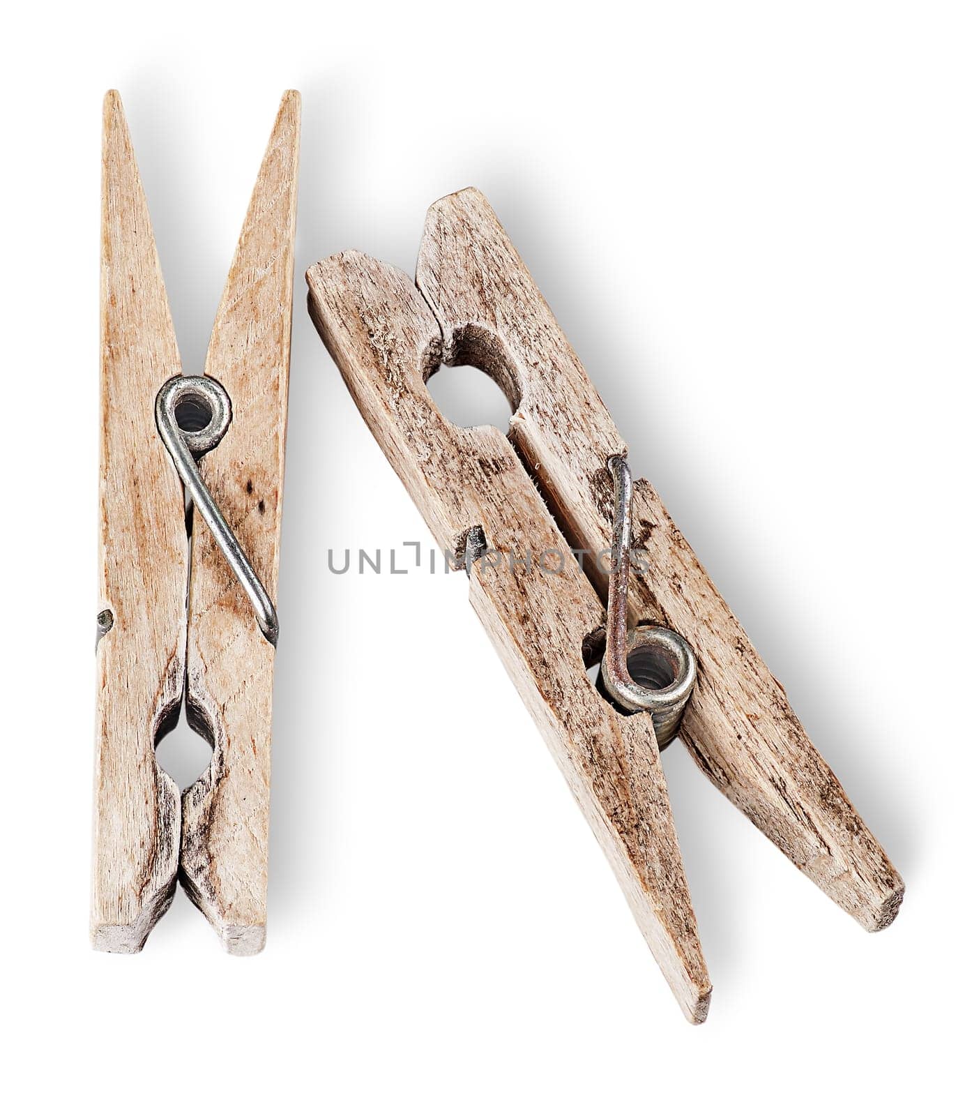 Two old wooden clothespins beside isolated on white background