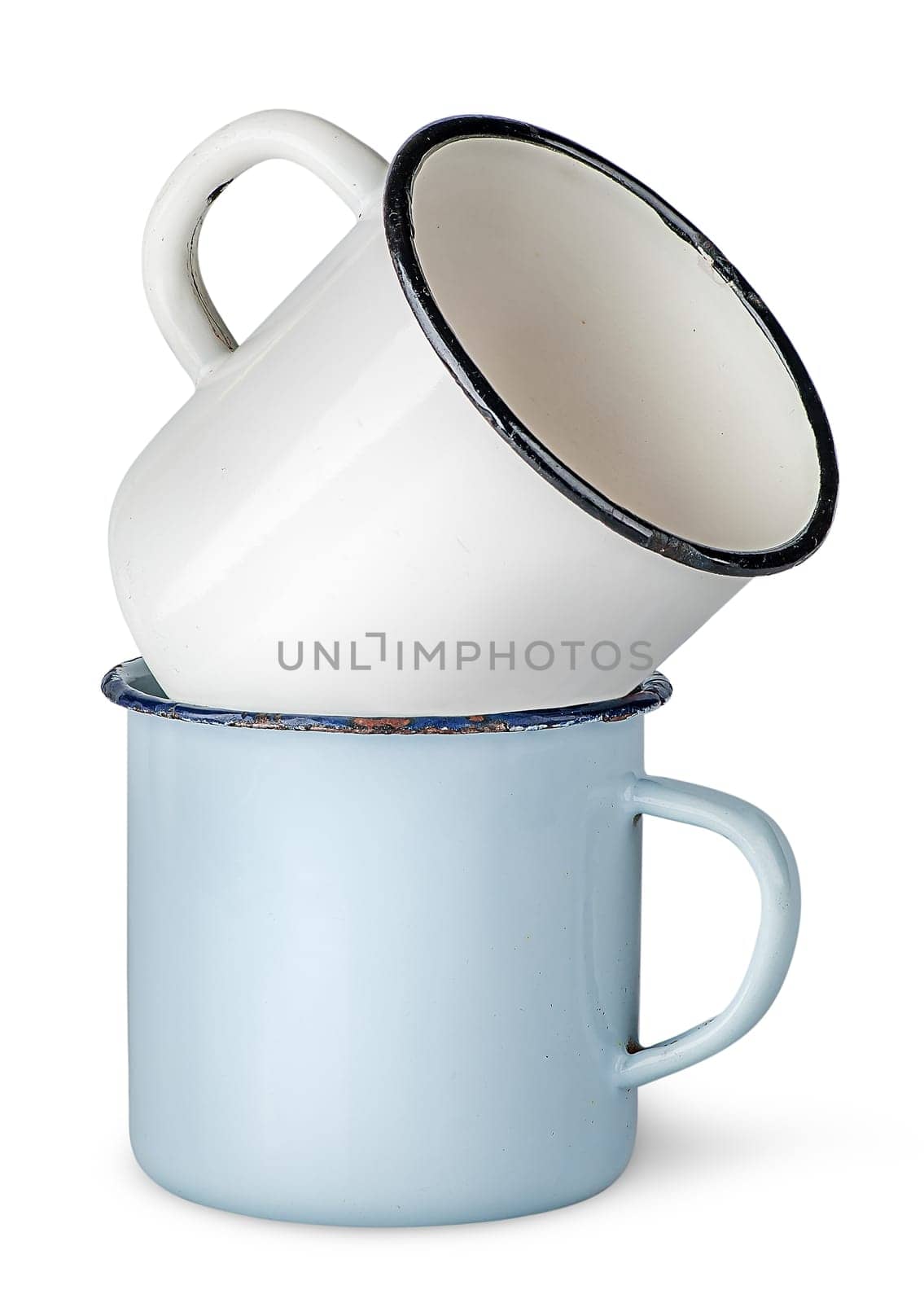 Two old enameled mugs on each other isolated on white background