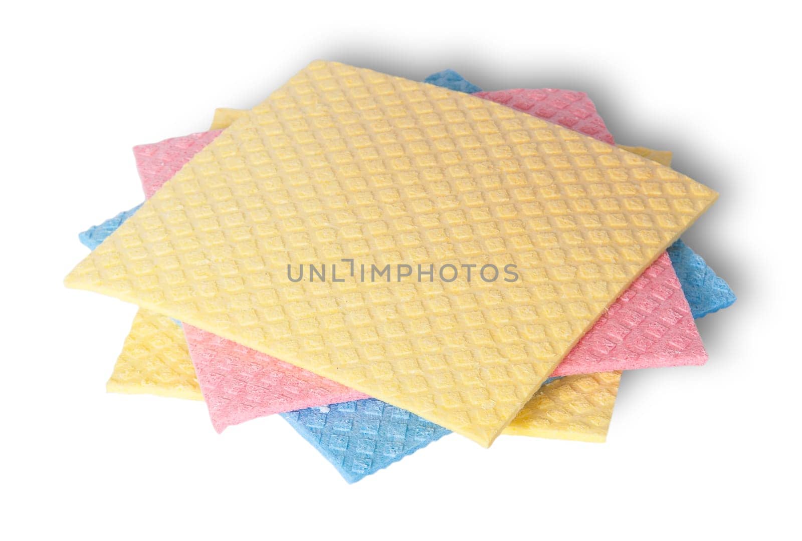 Multicolored sponges for dishwashing in a chaotic order isolated on white background